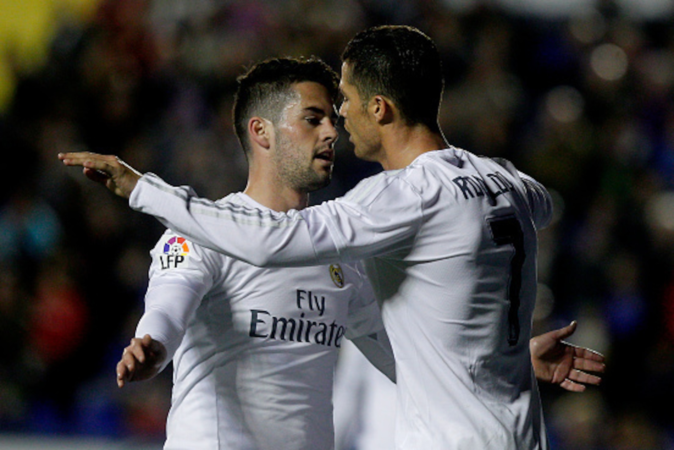 Real Madrid's midfielder Isco (L) celebrates a goal with Real Madrid's Portuguese forward Cristiano Ronaldo during the Spanish league football match Levante UD vs Real Madrid CF at the Ciutat de Valencia stadium in Valencia on March 2, 2016. / AFP / Jose 