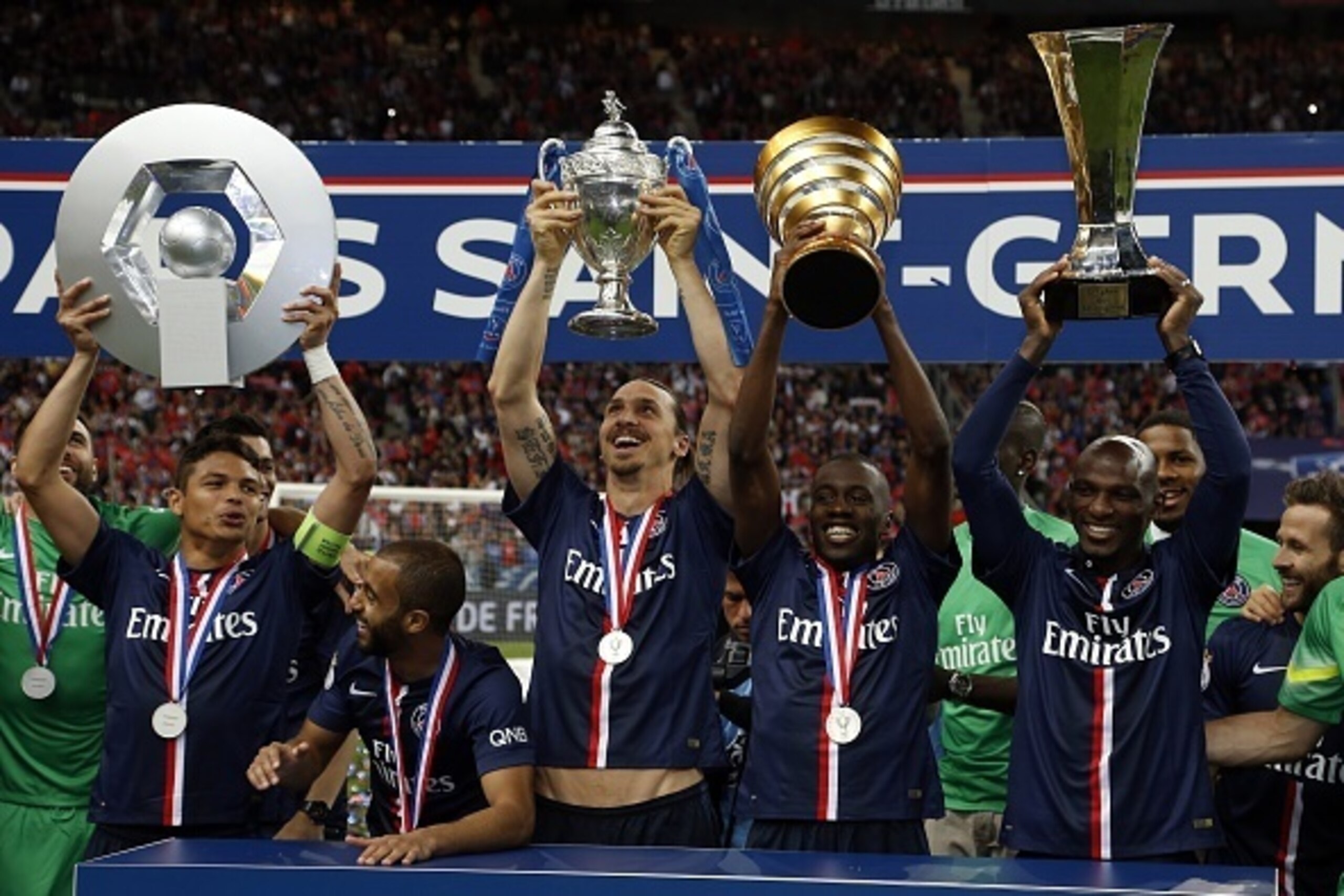 (From L) Paris Saint-Germain's Brazilian defender Thiago Silva holding up the Ligue 1 trophy, Swedish forward Zlatan Ibrahimovic holding up the French Cup trophy, midfielder Blaise Matuidi holding the French League Cup and defender Zoumana Camara holding 