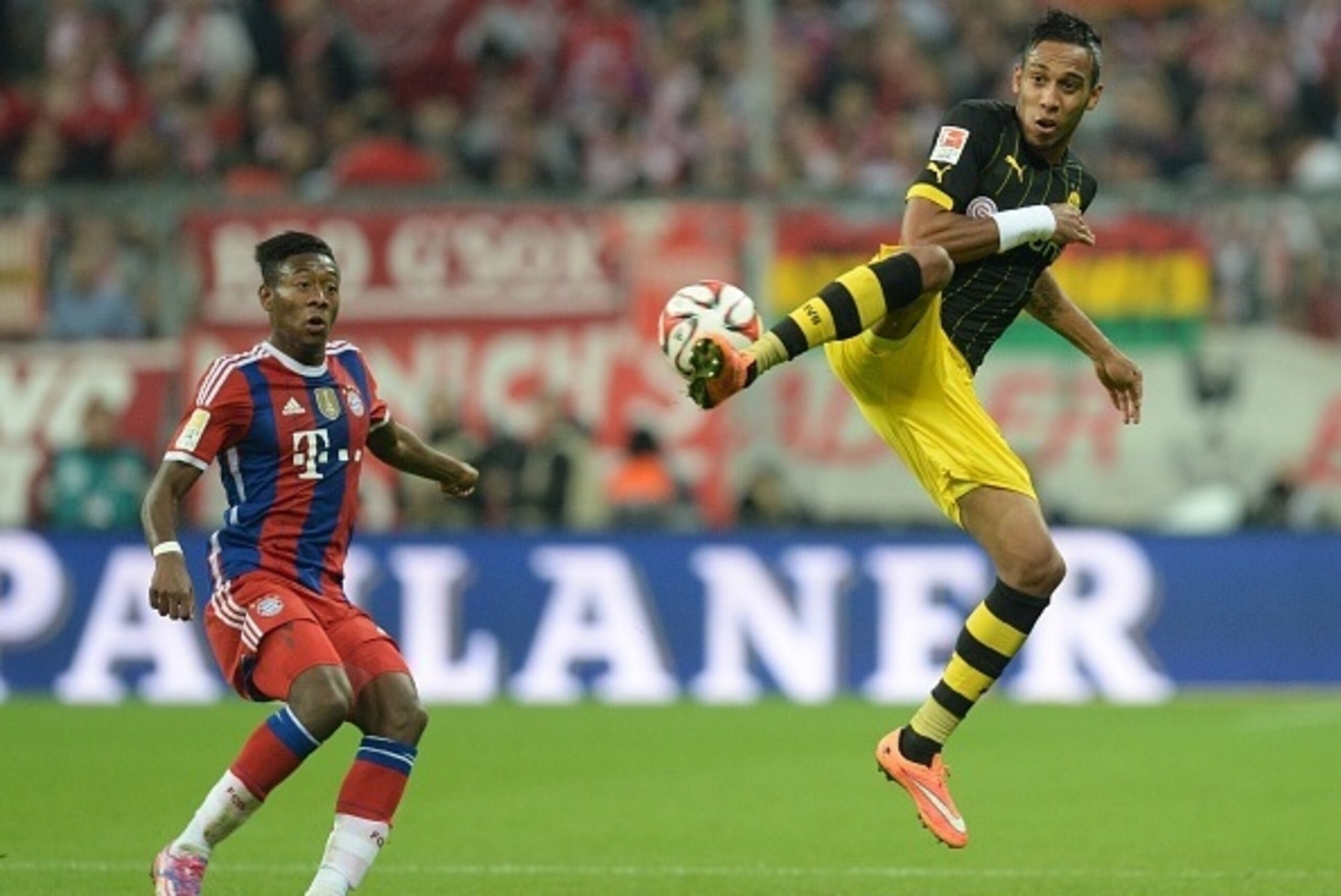 Bayern Munich's Austrian midfielder David Alaba (L) and Dortmund's Gabonese striker Pierre-Emerick Aubameyang (R) vie for the ball during the German first division Bundesliga football match FC Bayern Munich vs Borussia Dortmund in Munich, southern Germany