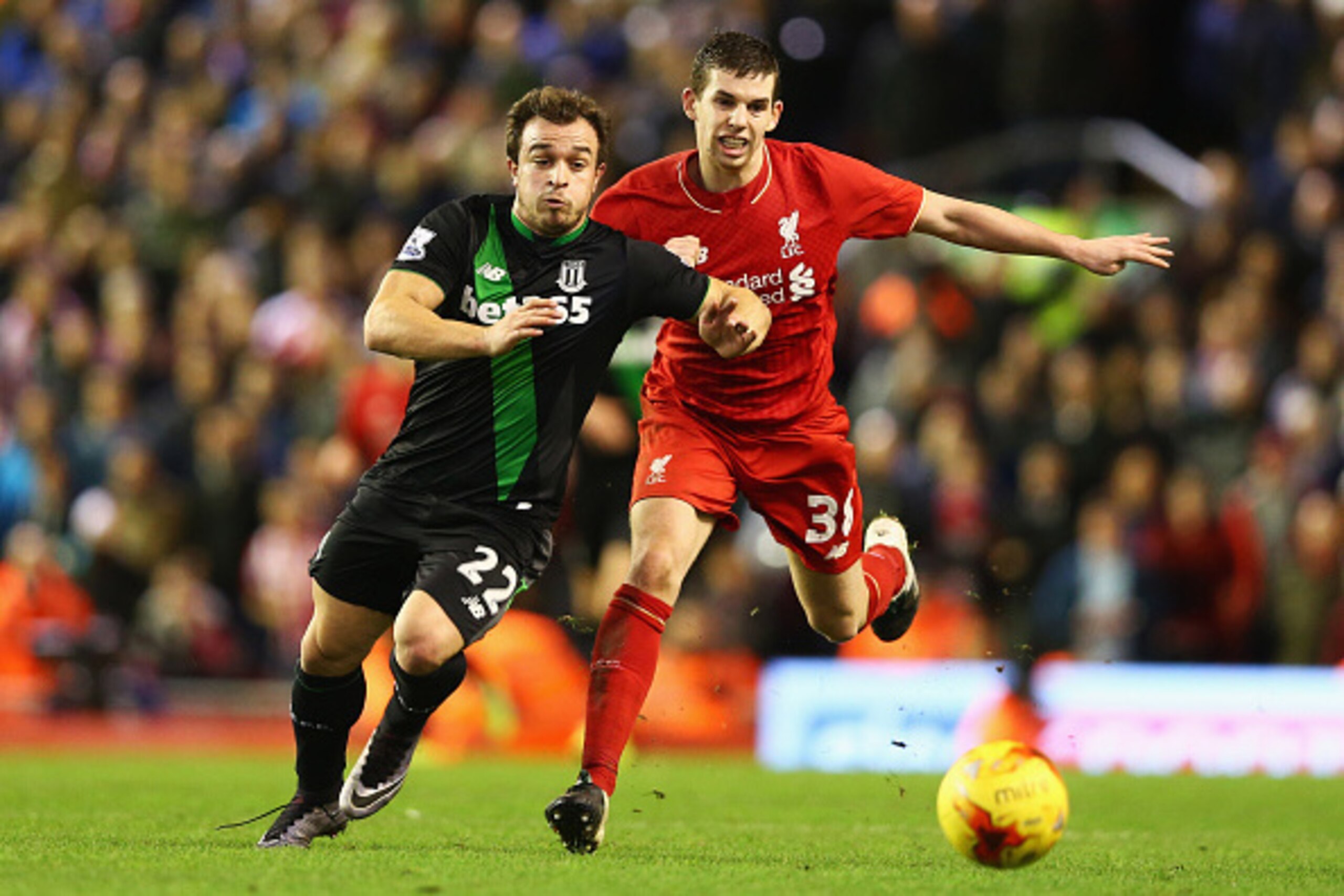 LIVERPOOL, ENGLAND - JANUARY 26:  Xherdan Shaqiri of Stoke City and Jon Flanagan of Liverpool chase the ball during the Capital One Cup semi final second leg match between Liverpool and Stoke City at Anfield on January 26, 2016 in Liverpool, England.  (Ph