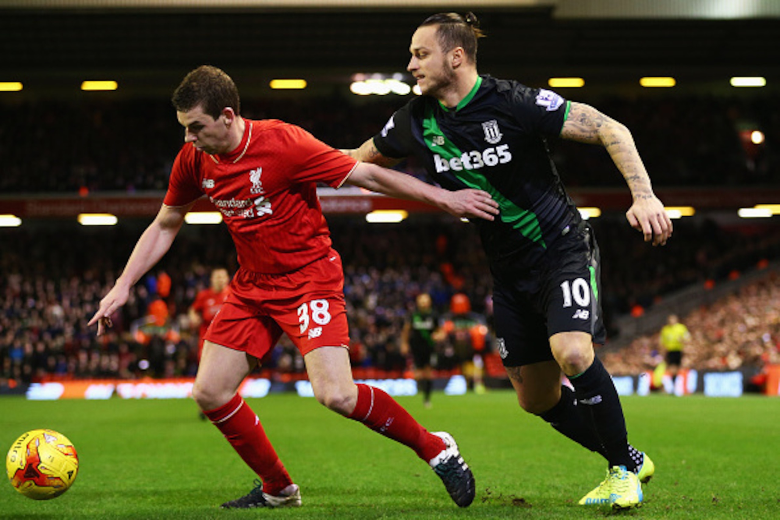 LIVERPOOL, ENGLAND - JANUARY 26:  Jon Flanagan of Liverpool holds off Marko Arnautovic of Stoke City during the Capital One Cup semi final second leg match between Liverpool and Stoke City at Anfield on January 26, 2016 in Liverpool, England.  (Photo by C