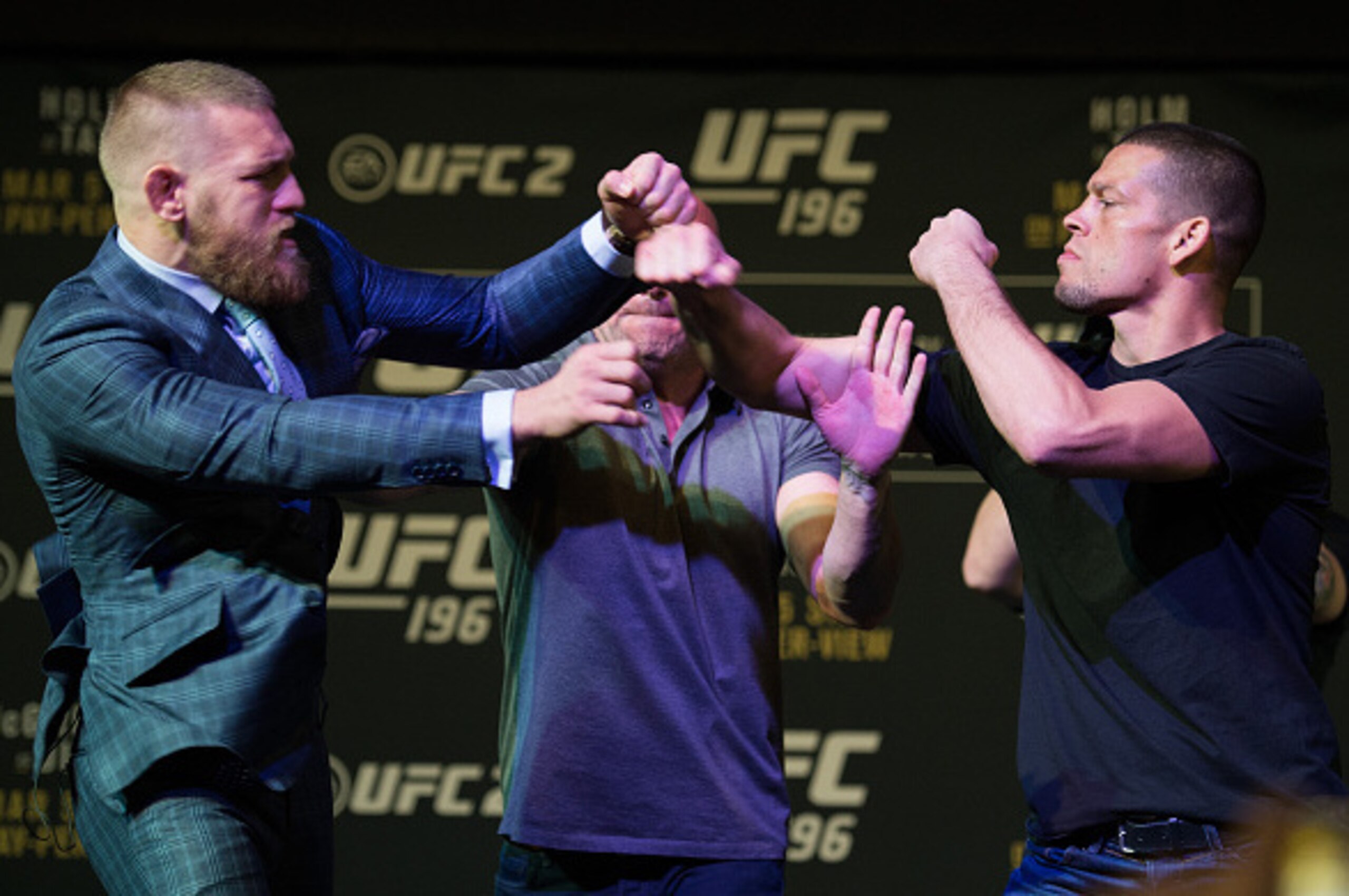 LAS VEGAS, NV - MARCH 3: (L-R) UFC featherweight champion Conor McGregor throws a punch towards Nate Diaz during the UFC 196 Press Conference at David Copperfield Theater in the MGM Grand Hotel/Casino on March 3, 2016 in Las Vegas, Nevada. (Photo by Bra LAS VEGAS, NV - MARCH 3: (L-R) UFC featherweight champion Conor McGregor throws a punch towards Nate Diaz during the UFC 196 Press Conference at David Copperfield Theater in the MGM Grand Hotel/Casino on March 3, 2016 in Las Vegas, Nevada. (Photo by Bra