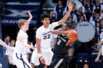 CINCINNATI, OH - FEBRUARY 17: J.P. Macura #55 and Kaiser Gates #22 of the Xavier Musketeers defend against Kris Dunn #3 of the Providence Friars in the second half of the game at Cintas Center on February 17, 2016 in Cincinnati, Ohio. Xavier defeated Prov