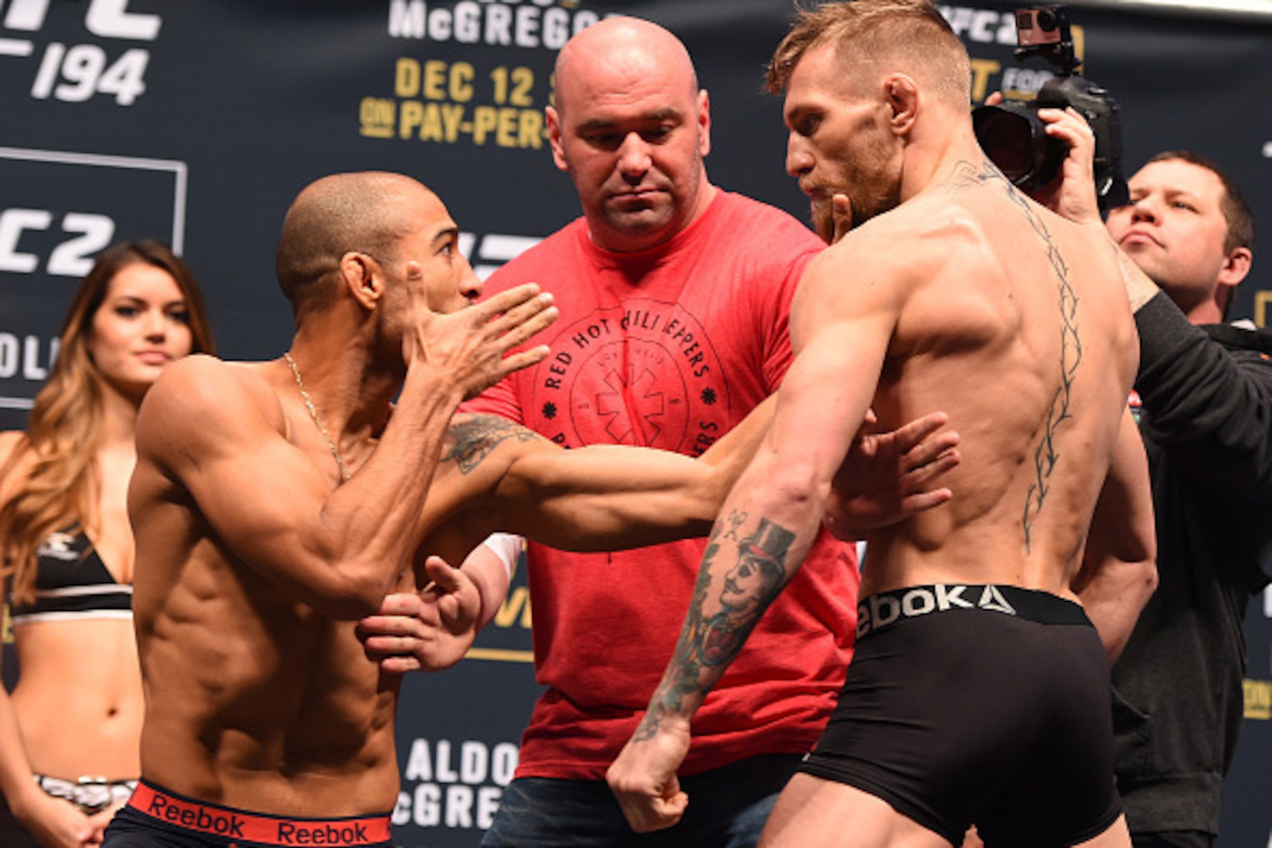 LAS VEGAS, NV - DECEMBER 11:  (L-R) UFC featherweight champion Jose Aldo of Brazil and interim UFC featherweight champion Conor McGregor of Ireland face off during the UFC 194 weigh-in inside MGM Grand Garden Arena on December 10, 2015 in Las Vegas, Nevad