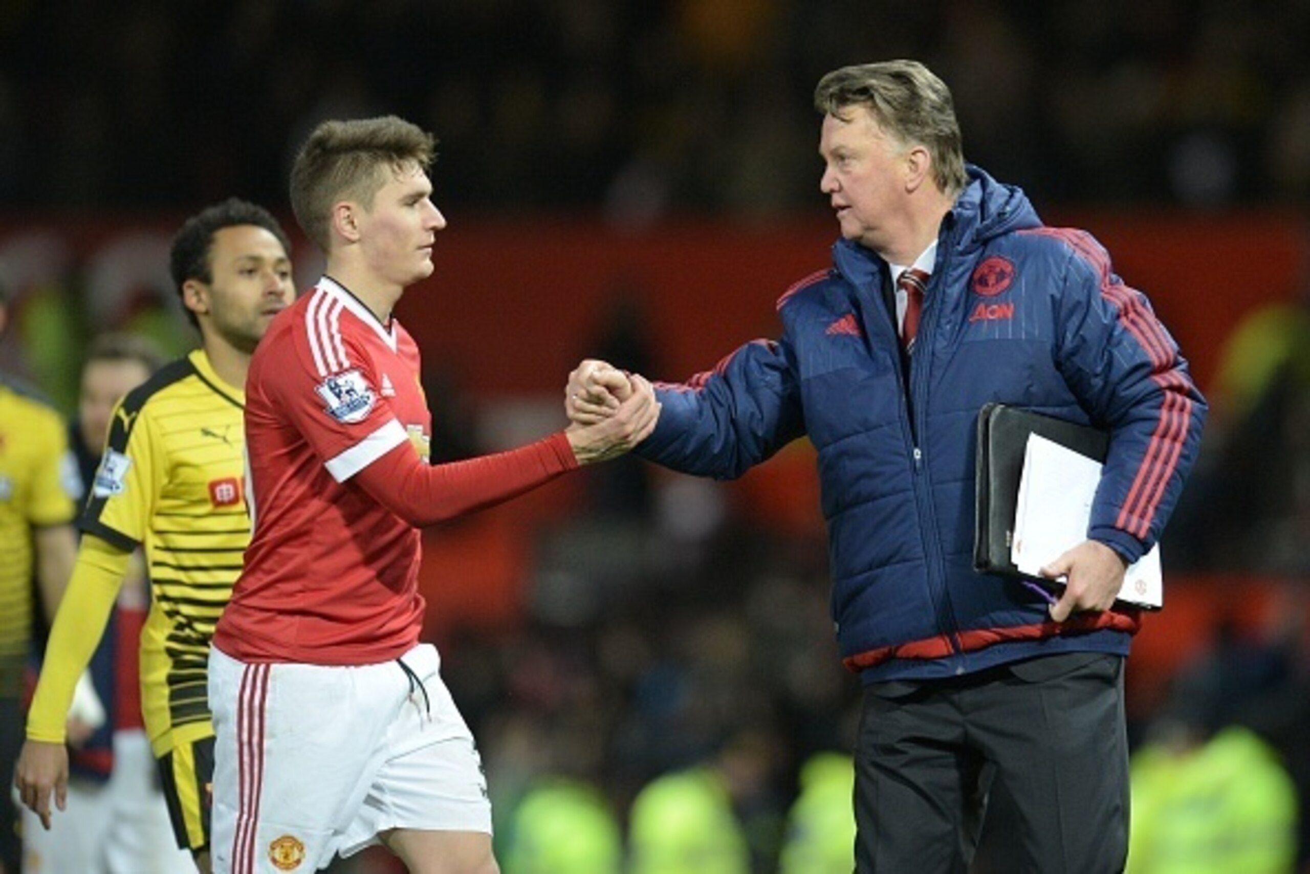 Manchester United's Dutch manager Louis van Gaal (R) shakes hands with Manchester United's Uruguayan defender Guillermo Varela (L) at the end of the English Premier League football match between Manchester United and Watford at Old Trafford in Manchester 