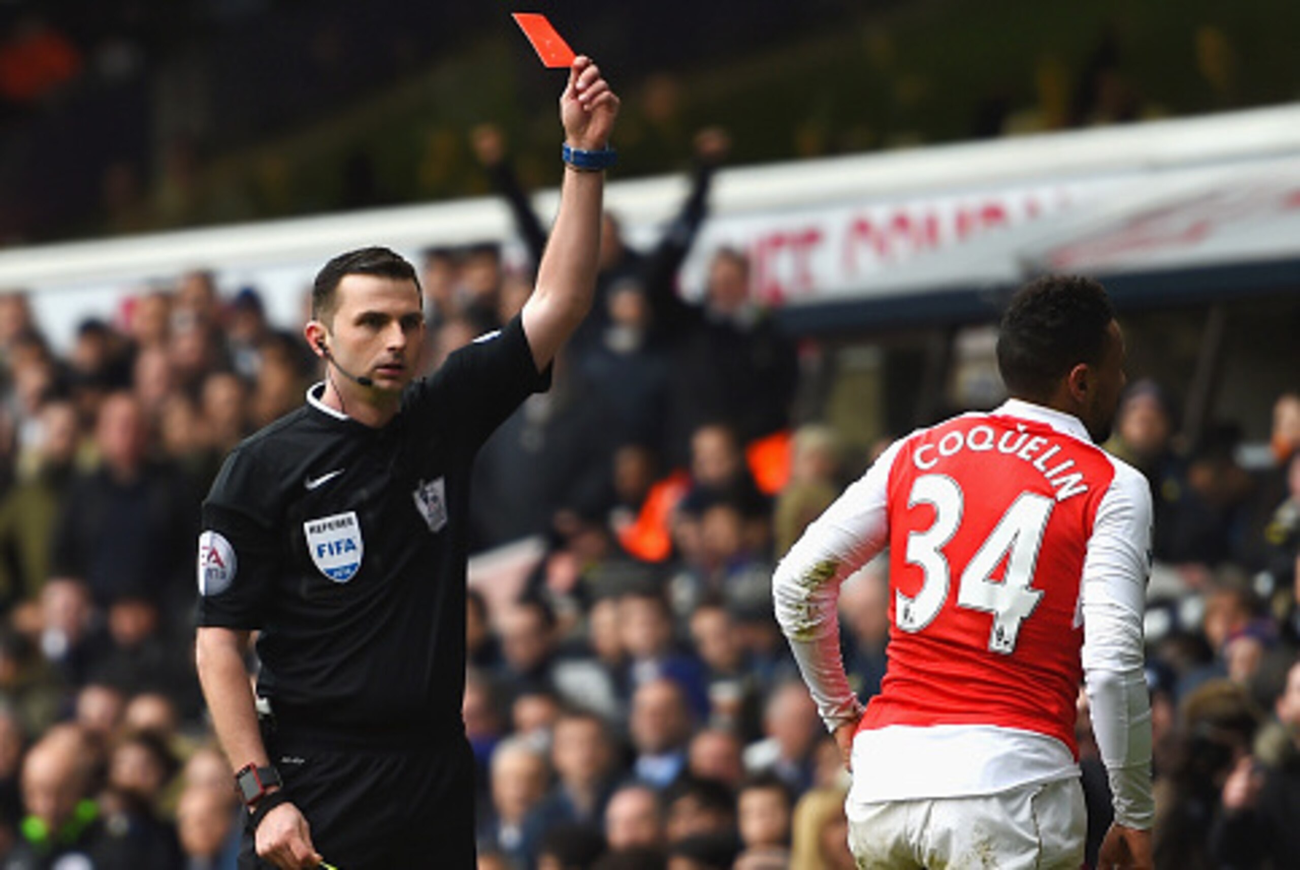 LONDON, ENGLAND - MARCH 05:  Francis Coquelin (R) of Arsenal is shown a red card by referee Michael Oliver (L) during the Barclays Premier League match between Tottenham Hotspur and Arsenal at White Hart Lane on March 5, 2016 in London, England.  (Photo b
