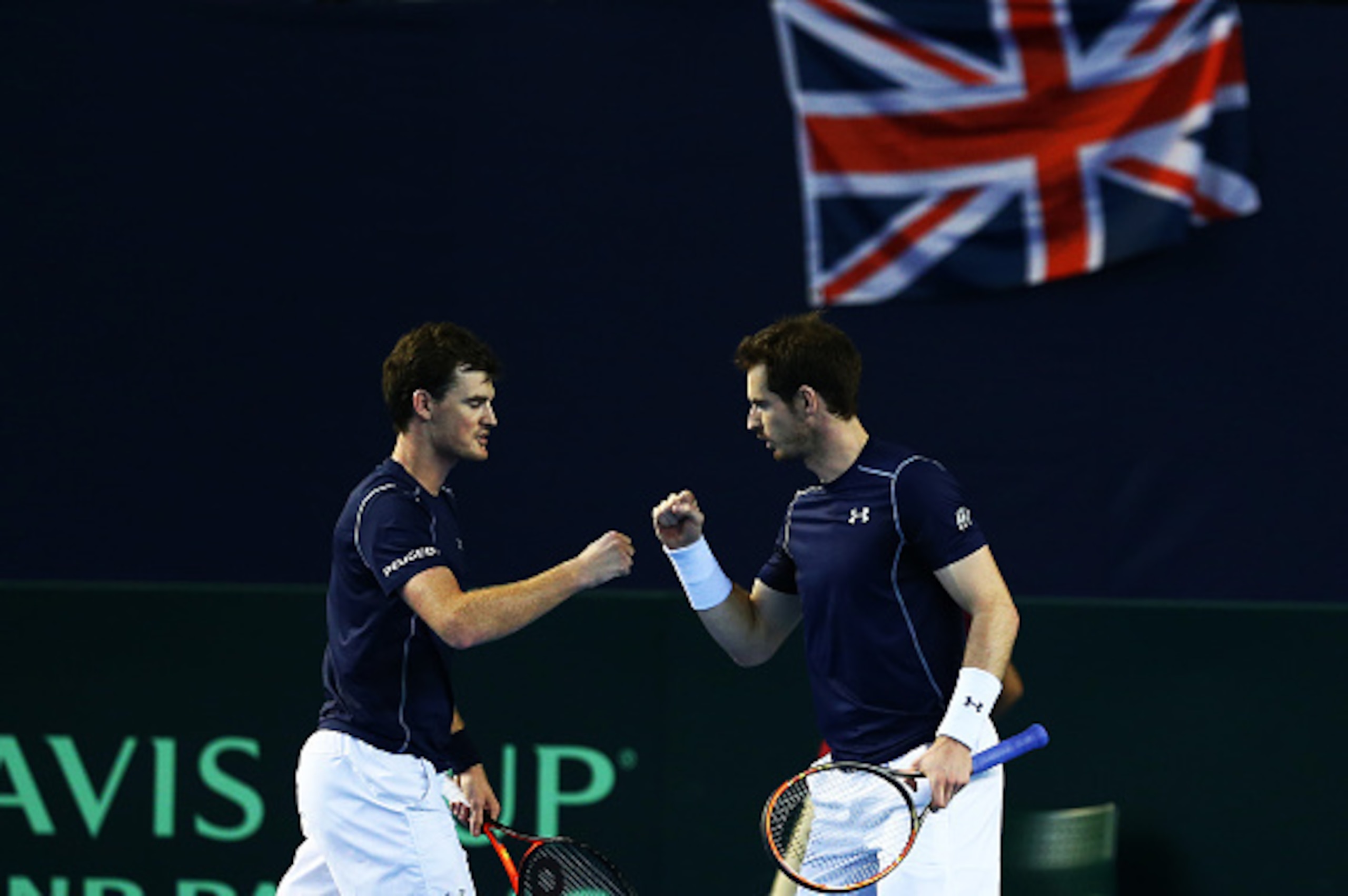 BIRMINGHAM, ENGLAND - MARCH 05:  Jamie Murray (L) and Andy Murray (R) of Great Britain cleebrate a point in the doubles match against Yasutaka Uchiyama and Yoshihito Nishioka of Japan on day two of the Davis Cup World Group 1st round tie between Great Bri