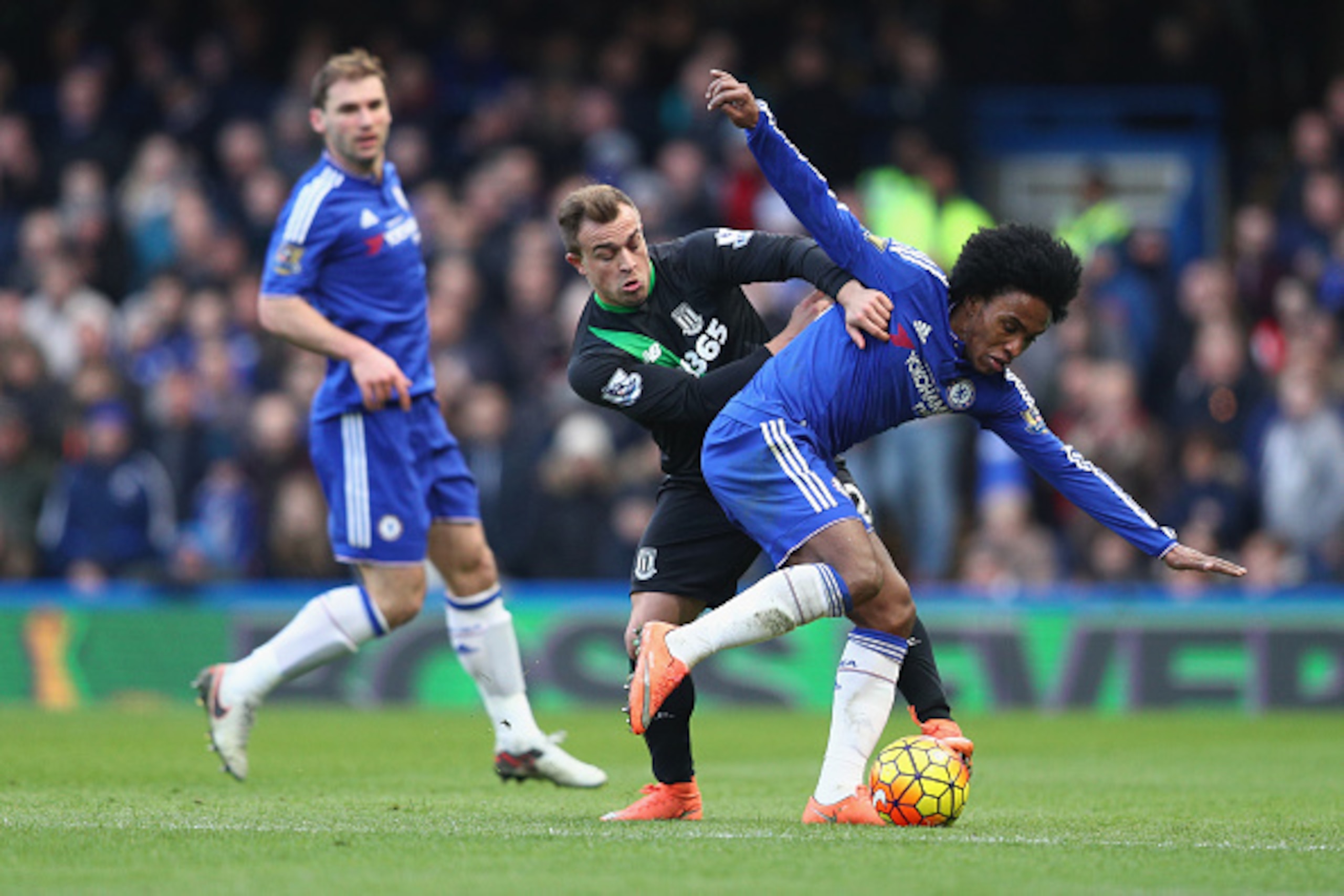 LONDON, ENGLAND - MARCH 05:  Willian of Chelsea and Xherdan Shaqiri of Stoke City compete for the ball during the Barclays Premier League match between Chelsea and Stoke City at Stamford Bridge on March 5, 2016 in London, England.  (Photo by Clive Mason/G