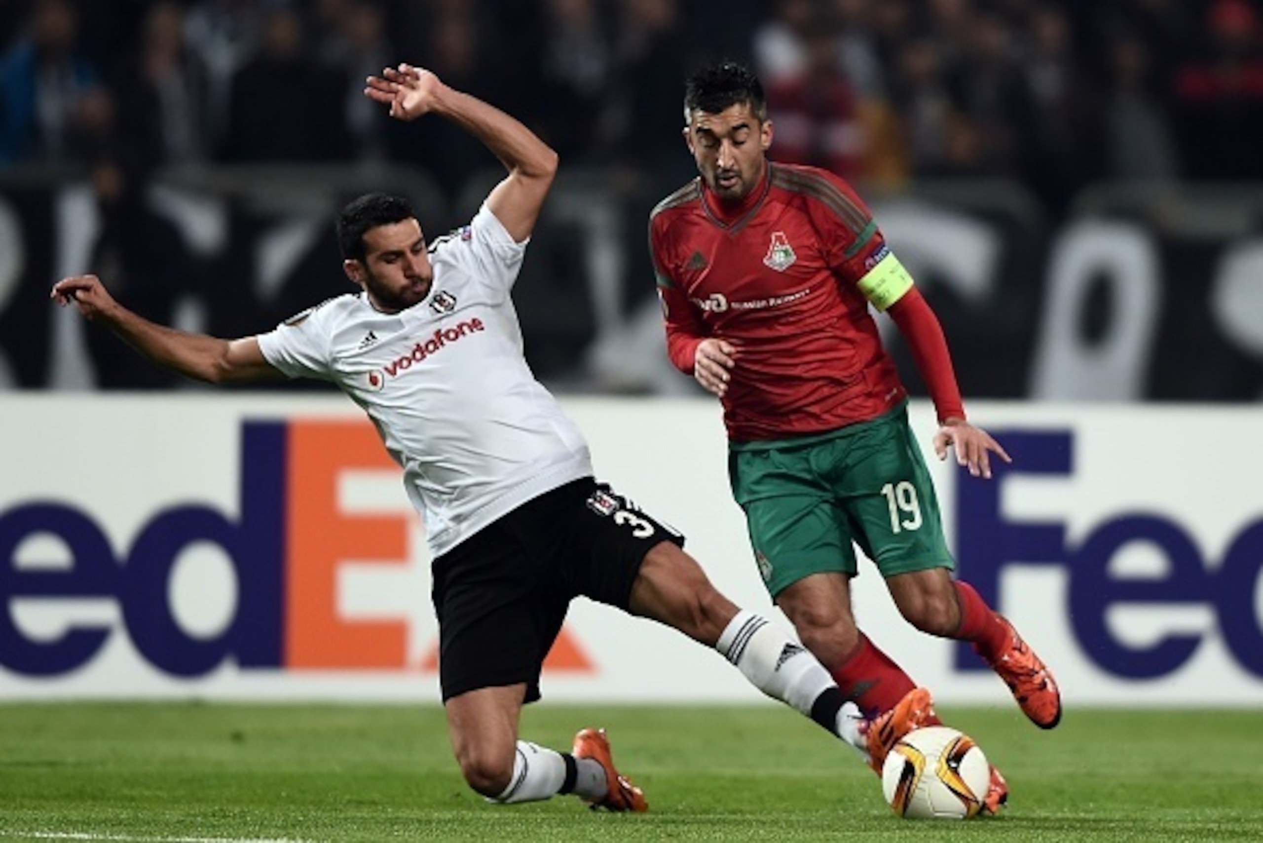 Lokomotiv's Russia forward Aleksandr Samedov (R) vies for the ball with Besiktas' Turkish defender Ismail Koybasi during the UEFA Europa League group H football match between Besiktas Istanbul and Lokomotiv Moscow at the Ataturk Olympic stadium on Novembe