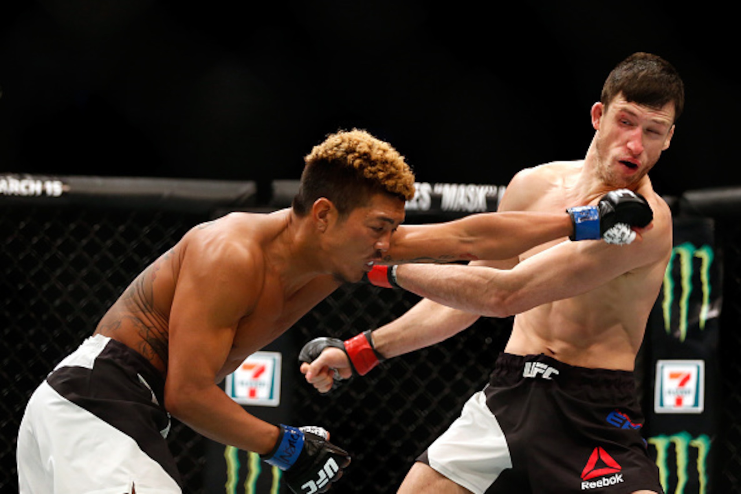 LAS VEGAS, NV - MARCH 05: (L-R) Teruto Ishihara of Japan punches Julian Erosa in their featherweight bout during the UFC 196 event inside MGM Grand Garden Arena on March 5, 2016 in Las Vegas, Nevada.  (Photo by Christian Petersen/Zuffa LLC/Zuffa LLC via G