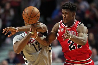 CHICAGO, IL - MARCH 05:  Jimmy Butler #21 of the Chicago Bulls fouls Dwight Howard #12 of the Houston Rockets at the United Center on March 5, 2016 in Chicago, Illinois. The Bulls defeated the Rockets 108-100. NOTE TO USER: User expressly acknowledges and