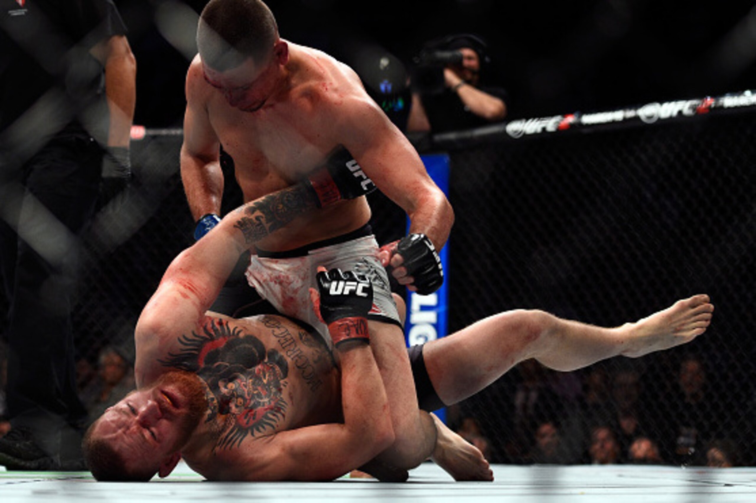LAS VEGAS, NV - MARCH 05:  Nate Diaz (top) punches Conor McGregor of Ireland during the UFC 196 event inside MGM Grand Garden Arena on March 5, 2016 in Las Vegas, Nevada.  (Photo by Jeff Bottari/Zuffa LLC/Zuffa LLC via Getty Images)