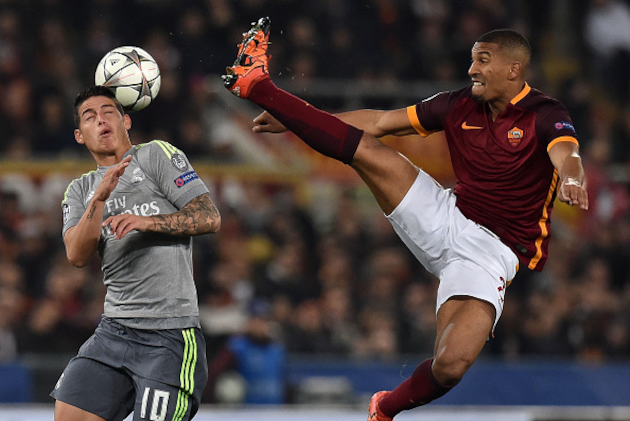 ROME, ITALY - FEBRUARY 17:  James Rodriguez of Real Madrid CF and William Vainqueur of AS Roma in action during the UEFA Champions League Round of 16 First Leg match between AS Roma and Real Madrid CF at Stadio Olimpico on February 17, 2016 in Rome, Italy