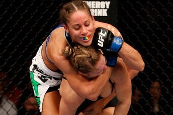 ANAHEIM, CA - FEBRUARY 23:  (L-R) Liz Carmouche applies a neck crank against Ronda Rousey in their women's bantamweight title fight during UFC 157 at Honda Center on February 23, 2013 in Anaheim, California.  (Photo by Josh Hedges/Zuffa LLC/Zuffa LLC via 