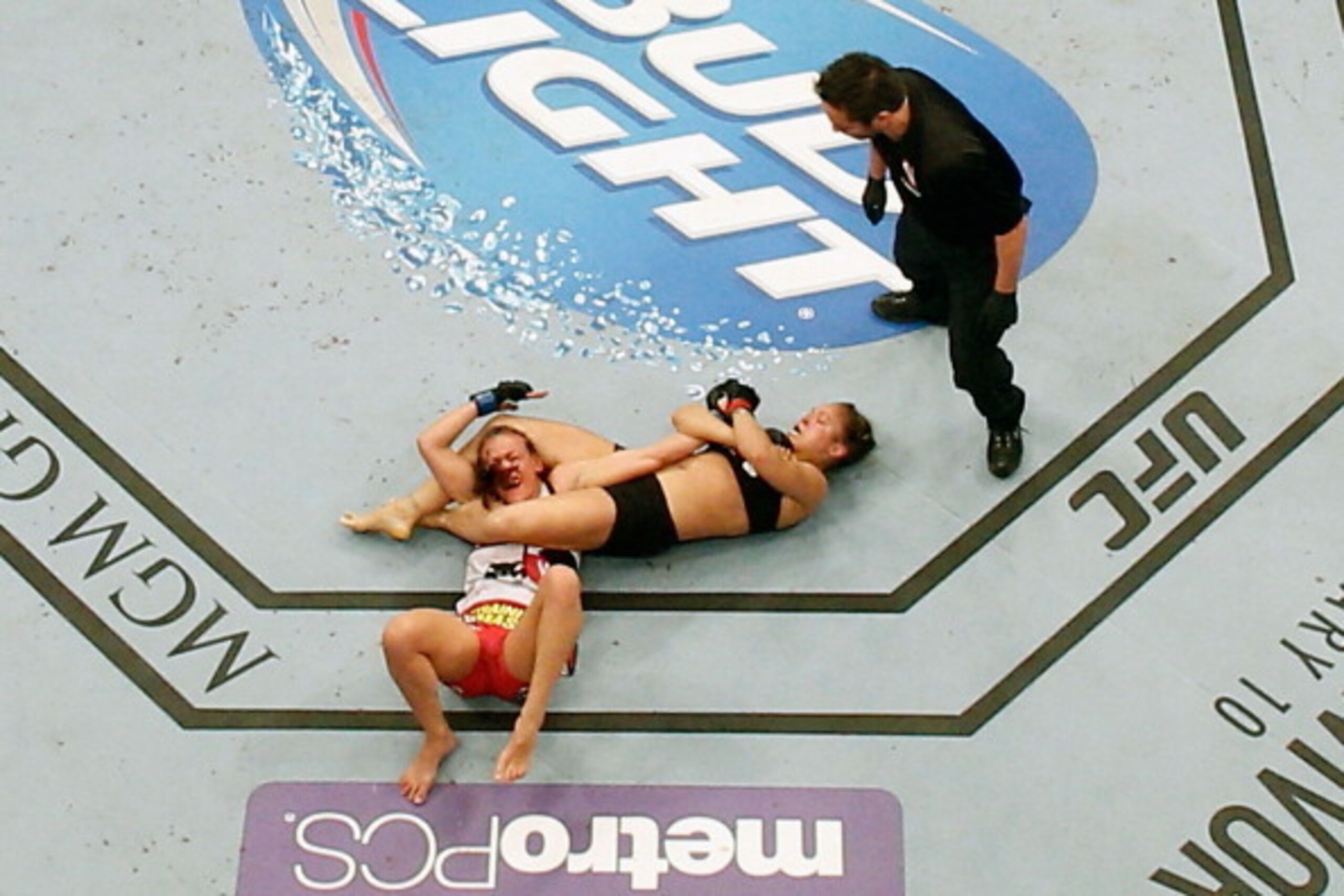 LAS VEGAS, NV - DECEMBER 28:  Ronda Rousey (black shorts) attempts to submit Miesha Tate in their UFC women's bantamweight championship bout during the UFC 168 event at the MGM Grand Garden Arena on December 28, 2013 in Las Vegas, Nevada. (Photo by Josh H