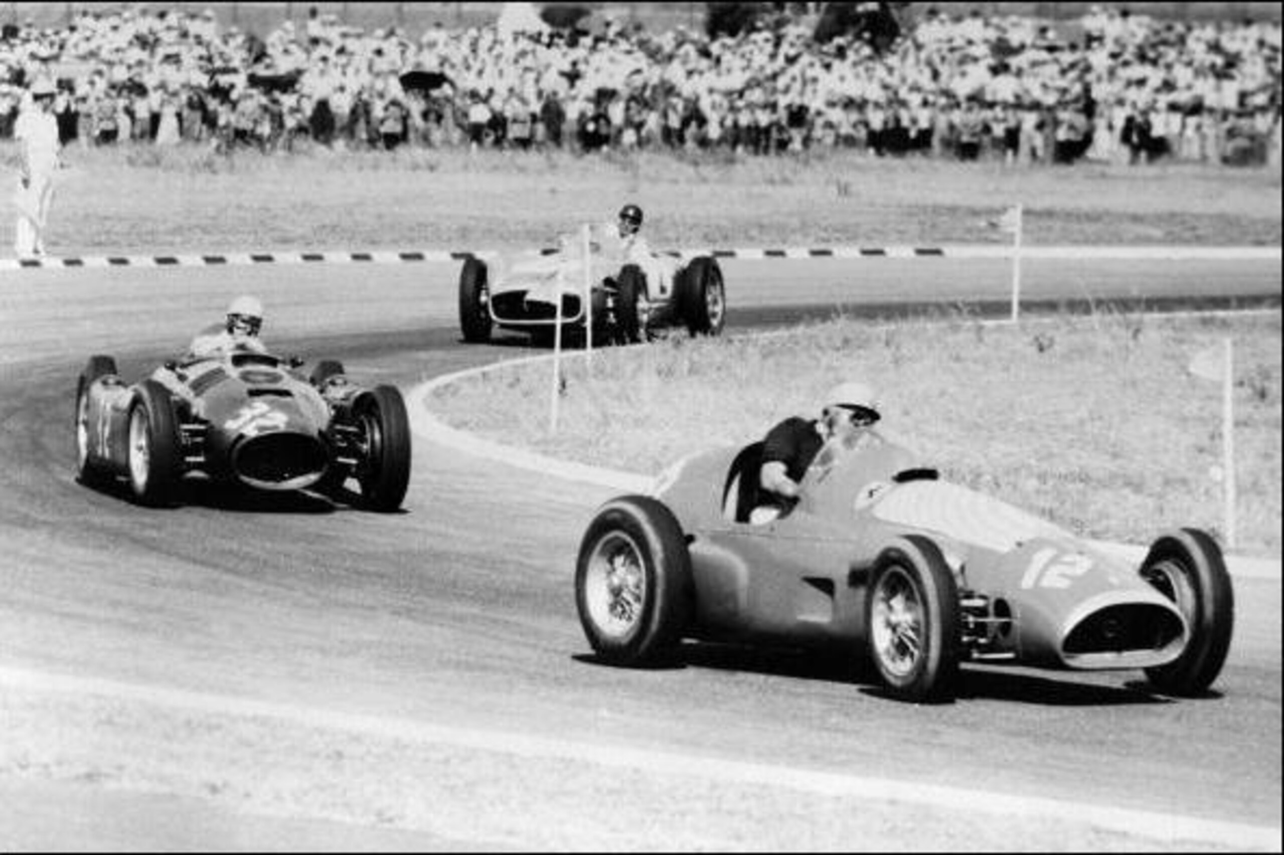 BUENOS AIRES, ARGENTINA - JANUARY21:  Picture taken 21 January 1955 at Buenos Aires race track of a Ferrari and a Lancia taking a curve ahead of the Mercedes of Argentinian driver Juan Manuel Fangio. Fangio won the race.  (Photo credit should read STF/AFP