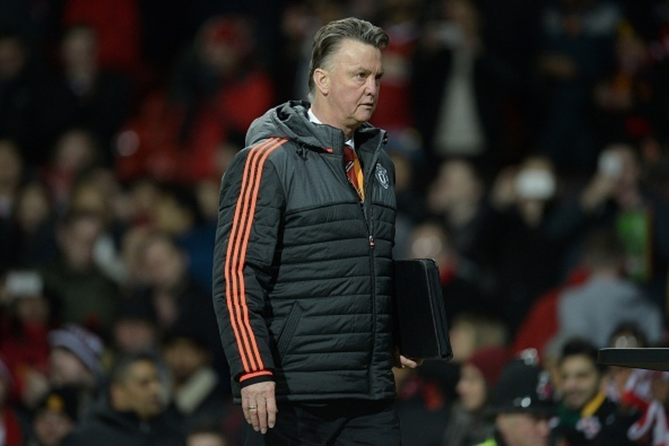 Manchester United's Dutch manager Louis van Gaal leaves the pitch following the UEFA Europa League round of 32, second leg football match between Manchester United and and FC Midtjylland at Old Trafford in Manchester, north west England, on February 25, 2