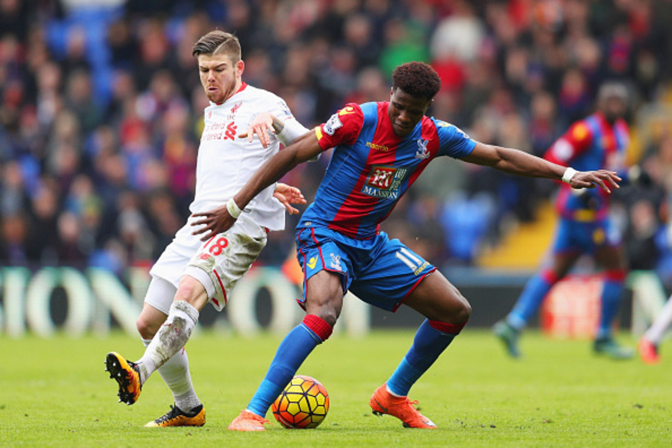 LONDON, ENGLAND - MARCH 06:  Wilfried Zaha of Crystal Palace holds off Alberto Moreno of Liverpool during the Barclays Premier League match between Crystal Palace and Liverpool at Selhurst Park on March 6, 2016 in London, England.  (Photo by Paul Gilham/G
