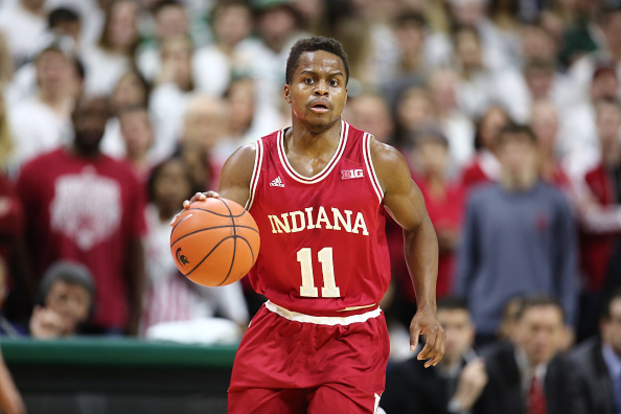 EAST LANSING, MI - FEBRUARY  14:  Yogi Ferrell #11 of the Indiana Hoosiers brings the ball up the court in the first half during the game against the Michigan State Spartans at the Breslin Center on February 14, 2016 in East Lansing, Michigan. (Photo by R