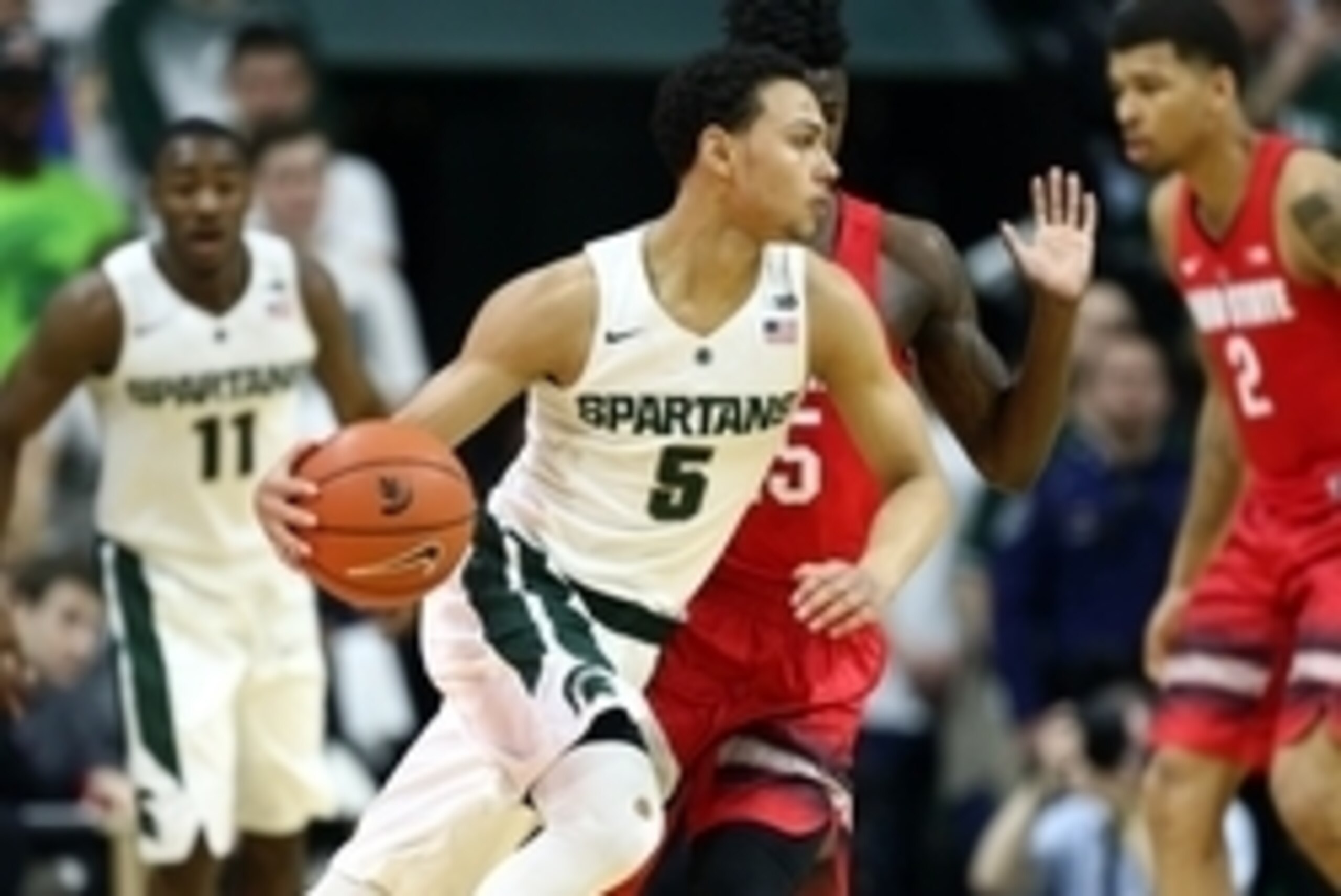 Mar 5, 2016; East Lansing, MI, USA; Michigan State Spartans guard Bryn Forbes (5) dribbles the ball as Ohio State Buckeyes guard Kam Williams (15) defends during the first half at Jack Breslin Student Events Center. Mandatory Credit: Mike Carter-USA TODAY