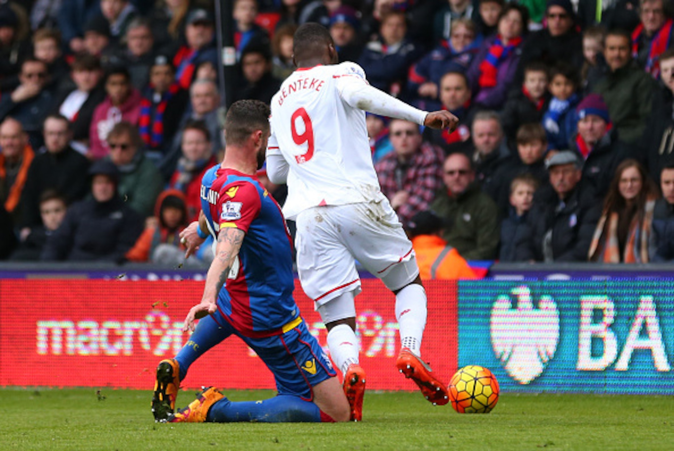 LONDON, ENGLAND - MARCH 06:  The knee of Damien Delaney of Crystal Palace catches the foot of Christian Benteke of Liverpool and a penalty is given during the Barclays Premier League match between Crystal Palace and Liverpool at Selhurst Park on March 6, 