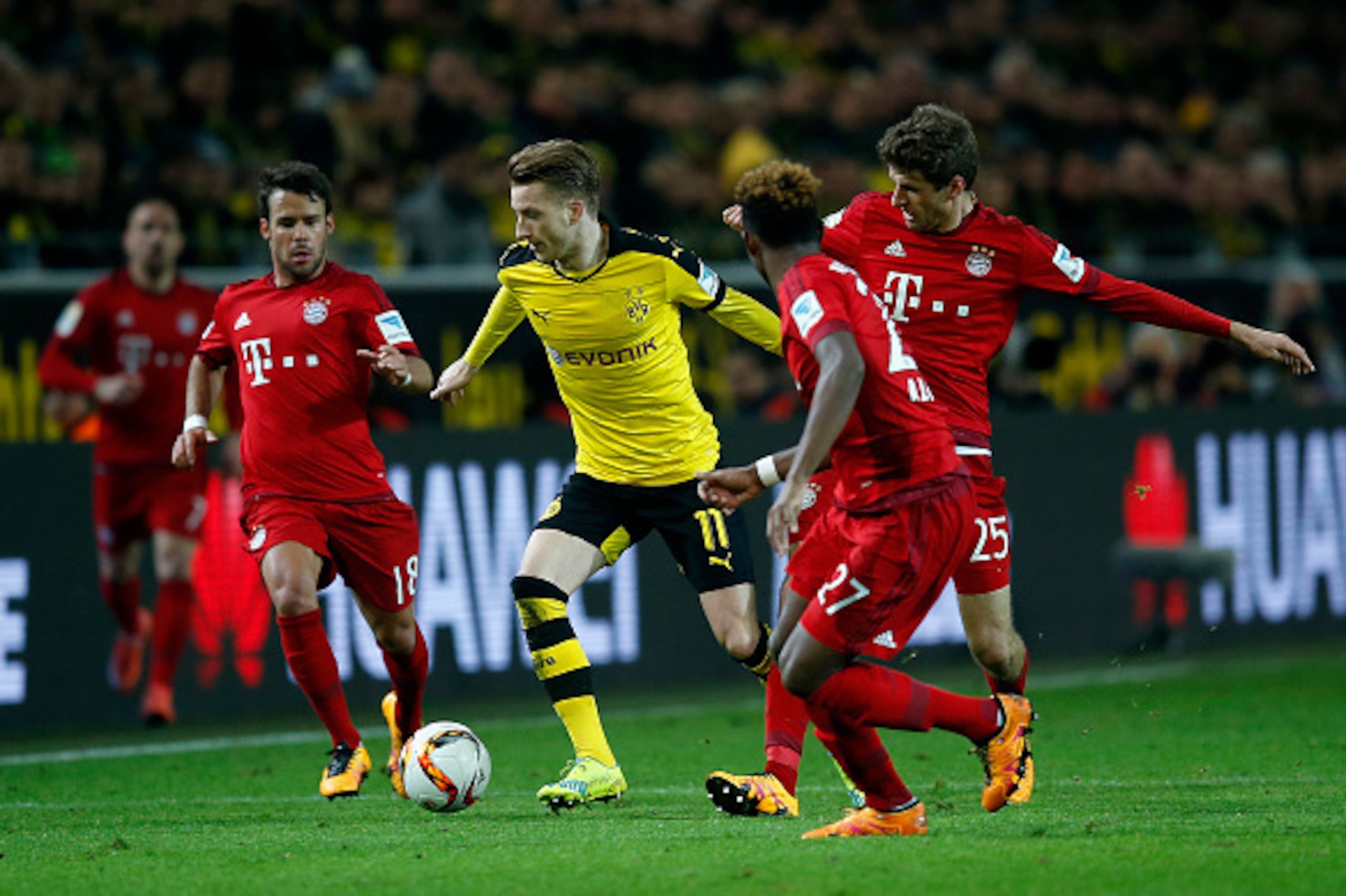DORTMUND, GERMANY - MARCH 05:  Marco Reus (C) of Borussia Dortmund is challenged by players of Bayern Munich during the Bundesliga match between Borussia Dortmund and FC Bayern Muenchen at Signal Iduna Park on March 5, 2016 in Dortmund, Germany.bs  (Photo