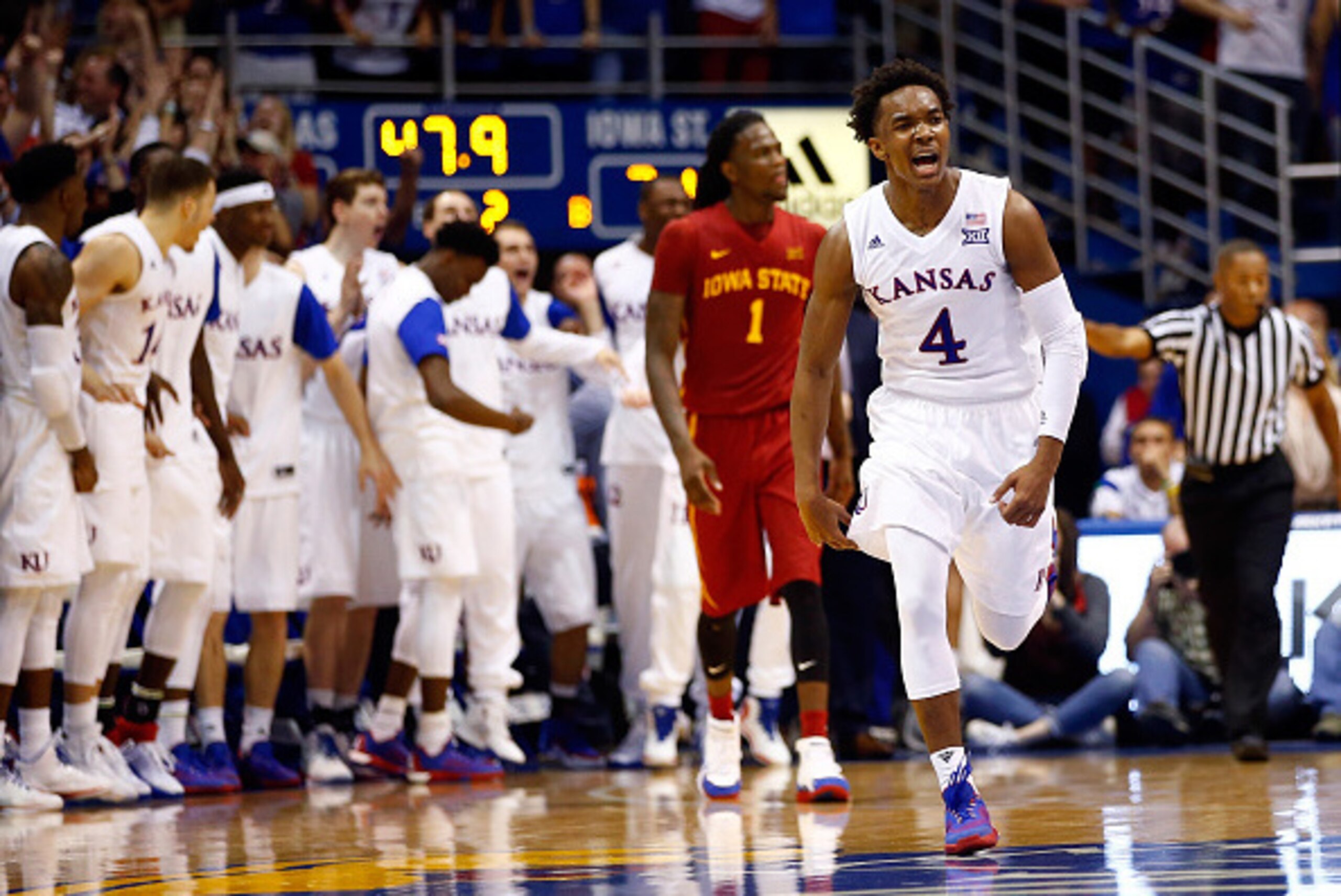 LAWRENCE, KS - MARCH 05: Devonte' Graham #4 of the Kansas Jayhawks reacts after making a three-pointer as Jameel McKay #1 of the Iowa State Cyclones looks on during the 2nd half of the game at Allen Fieldhouse on March 5, 2016 in Lawrence, Kansas. (Phot LAWRENCE, KS - MARCH 05: Devonte' Graham #4 of the Kansas Jayhawks reacts after making a three-pointer as Jameel McKay #1 of the Iowa State Cyclones looks on during the 2nd half of the game at Allen Fieldhouse on March 5, 2016 in Lawrence, Kansas. (Phot