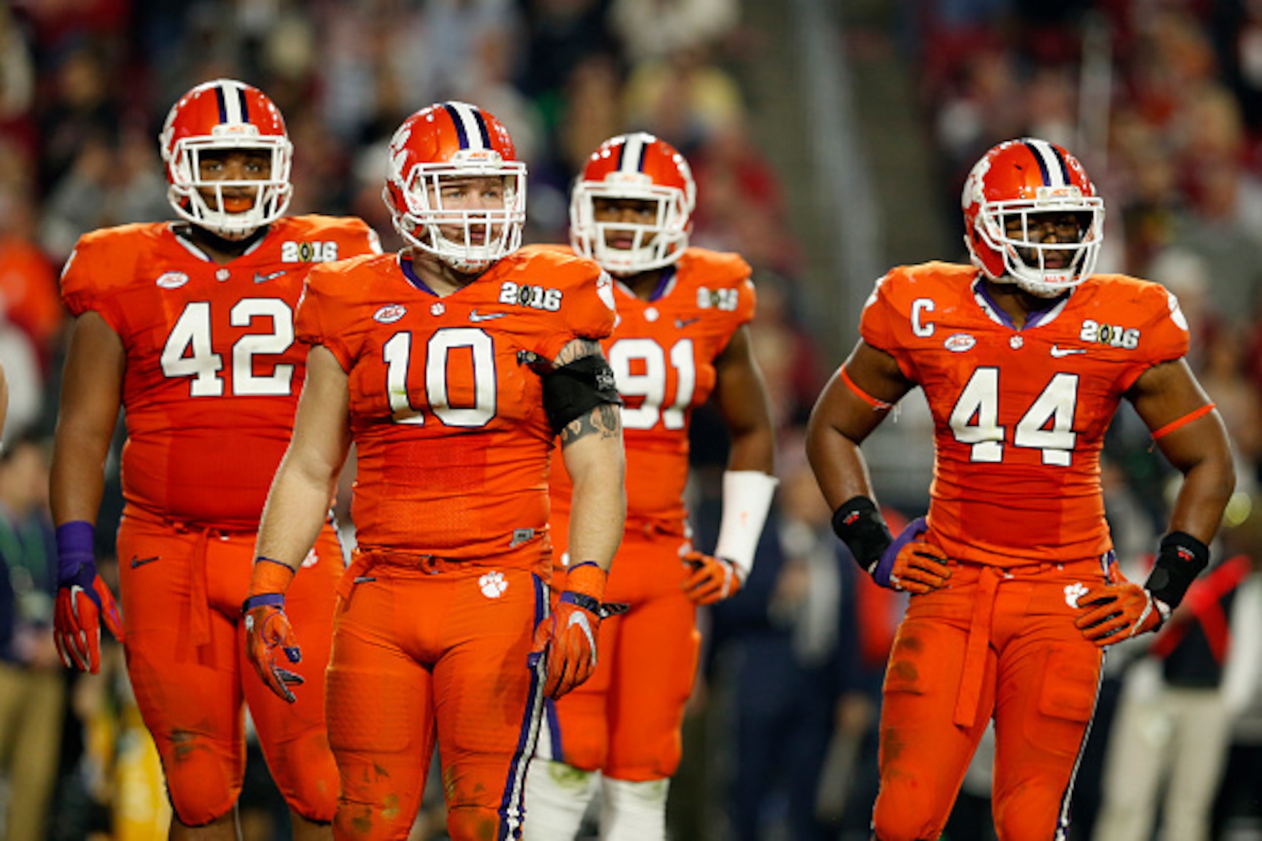 GLENDALE, AZ - JANUARY 11: Christian Wilkins #42, Ben Boulware #10, Austin Bryant #91 and B.J. Goodson #44 of the Clemson Tigers look on against the Alabama Crimson Tide during the 2016 College Football Playoff National Championship Game at University o GLENDALE, AZ - JANUARY 11: Christian Wilkins #42, Ben Boulware #10, Austin Bryant #91 and B.J. Goodson #44 of the Clemson Tigers look on against the Alabama Crimson Tide during the 2016 College Football Playoff National Championship Game at University o