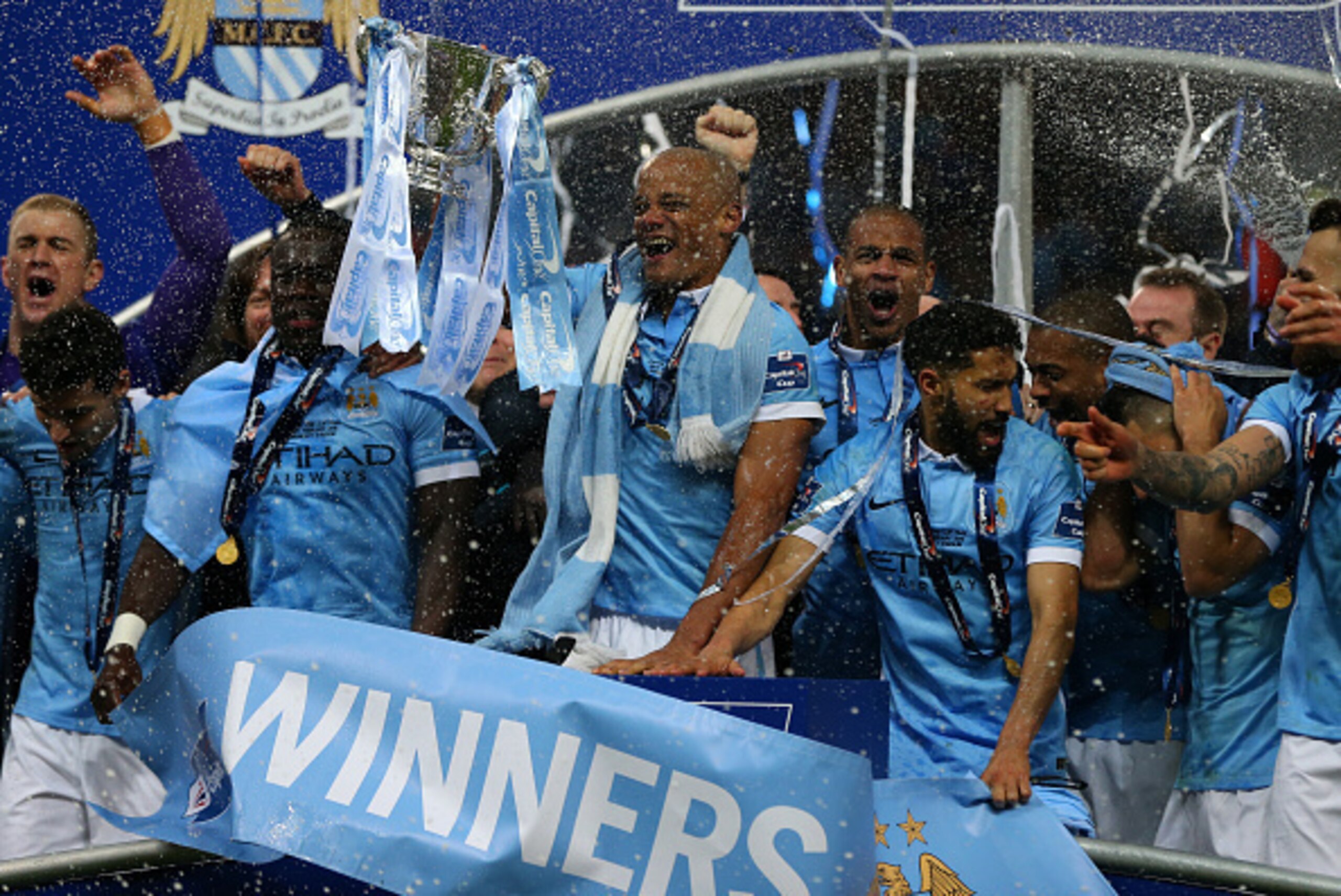 LONDON, ENGLAND - FEBRUARY 28 :  Vincent Kompany of Manchester City lifts the cup as Manchester City celebrate with the Capital One cup trophy after the Capital One Cup Final match between Liverpool and Manchester City at Wembley Stadium on February 28, 2