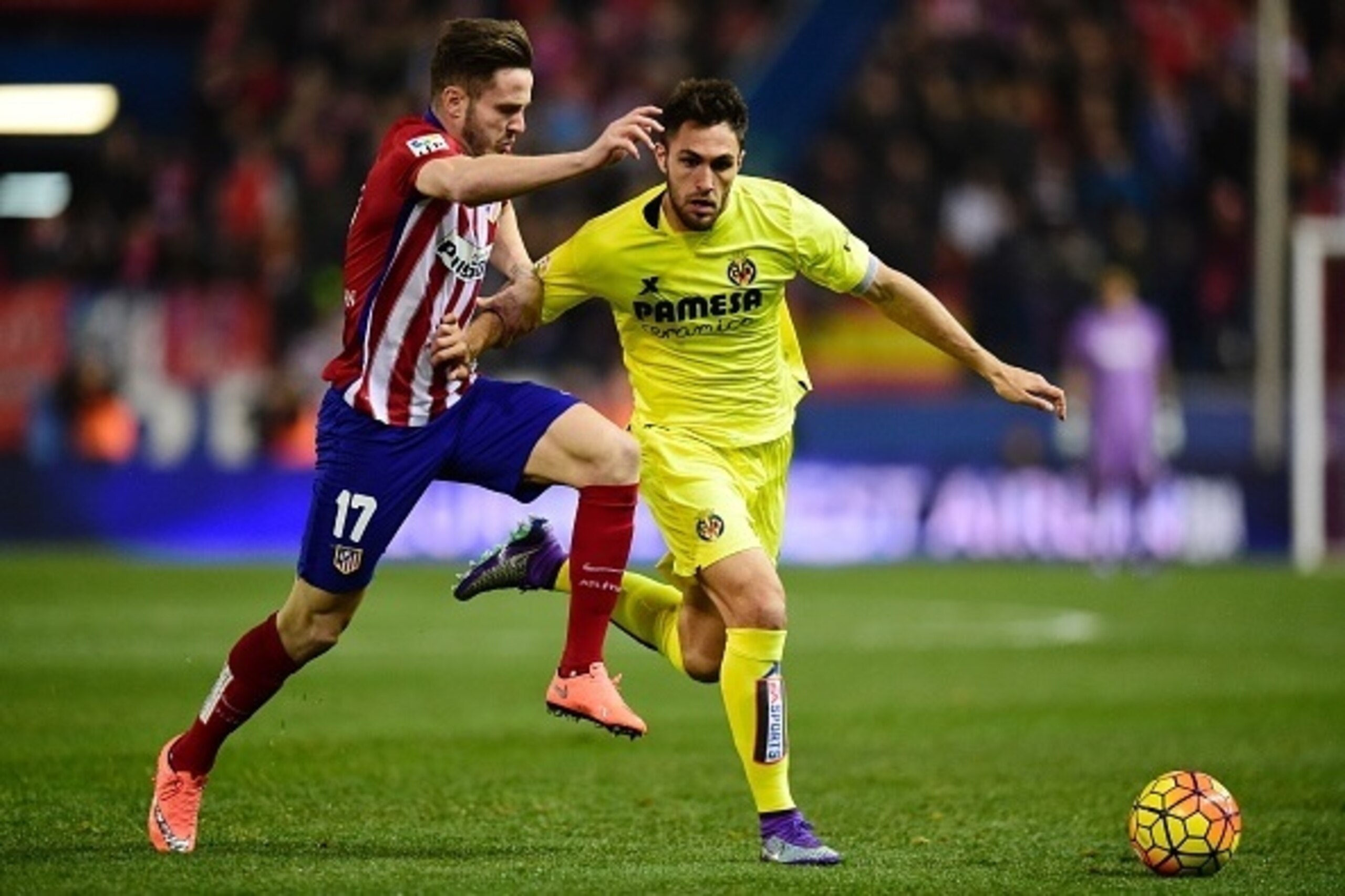 Atletico Madrid's midfielder Saul Niguez (L) vies with Villarreal's defender Victor Ruiz during the Spanish league football match Club Atletico de Madrid vs Villarreal CF at the Vicente Calderon stadium in Madrid on February 21, 2016. / AFP / JAVIER SORIA