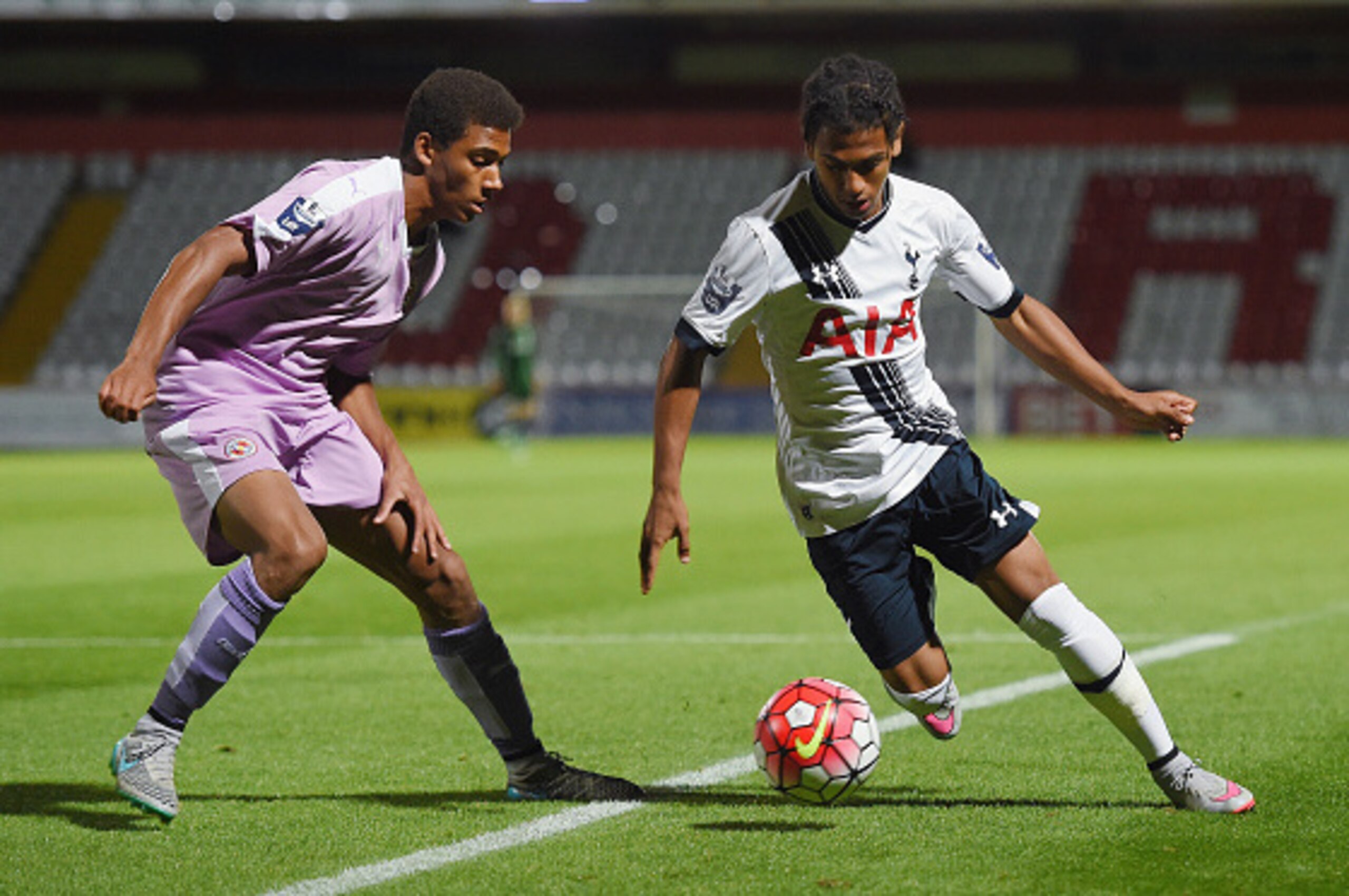 STEVENAGE, ENGLAND - SEPTEMBER 14: Marcus Edwards of Spurs in action with  Andy Rinomhota of Reading during the Barclays U21 Premier League match between Tottenham Hotspur and Reading at The Lamex Stadium on September 14, 2015 in Stevenage, England.  (Pho