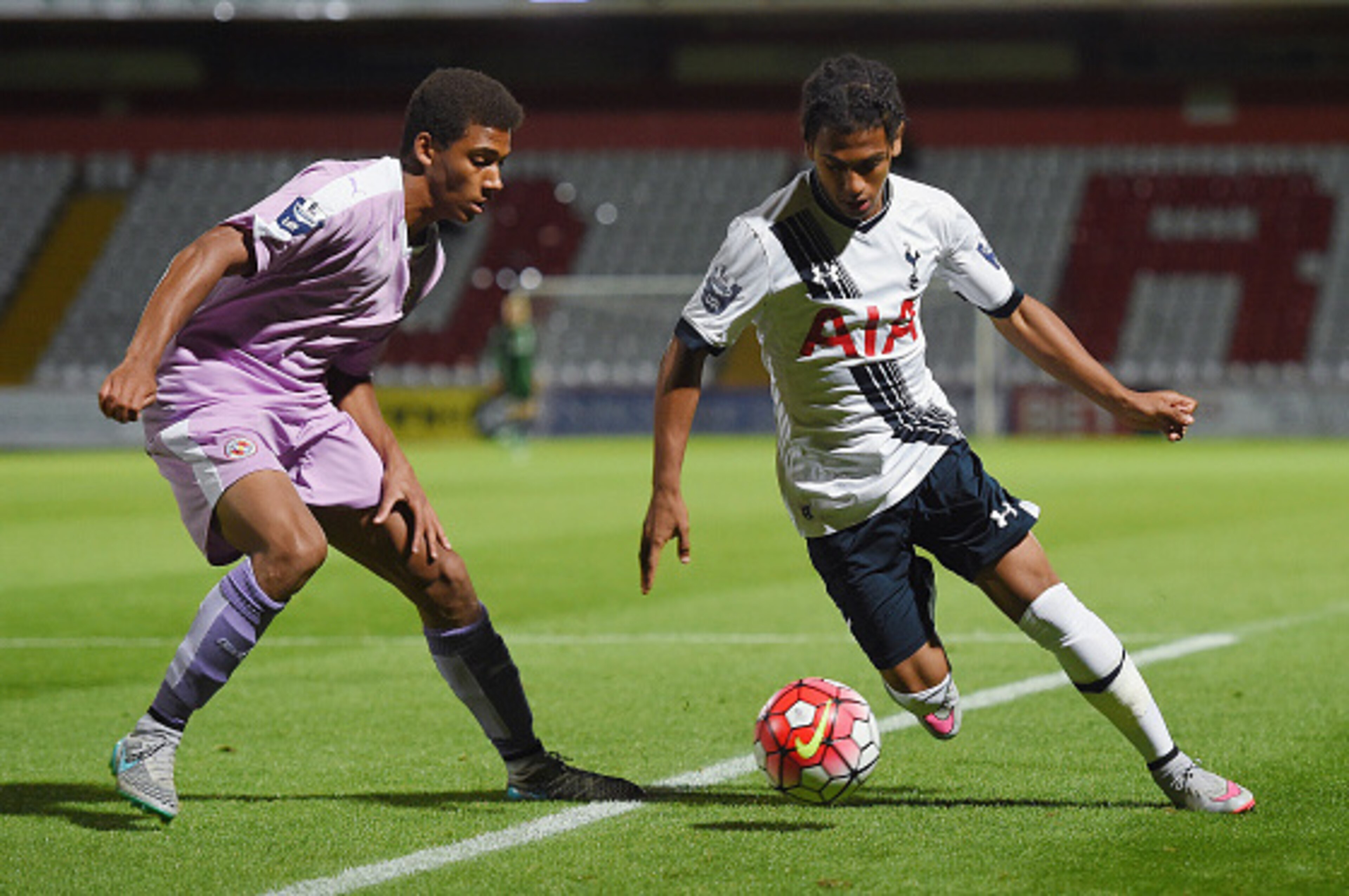 STEVENAGE, ENGLAND - SEPTEMBER 14: Marcus Edwards of Spurs in action with  Andy Rinomhota of Reading during the Barclays U21 Premier League match between Tottenham Hotspur and Reading at The Lamex Stadium on September 14, 2015 in Stevenage, England.  (Pho