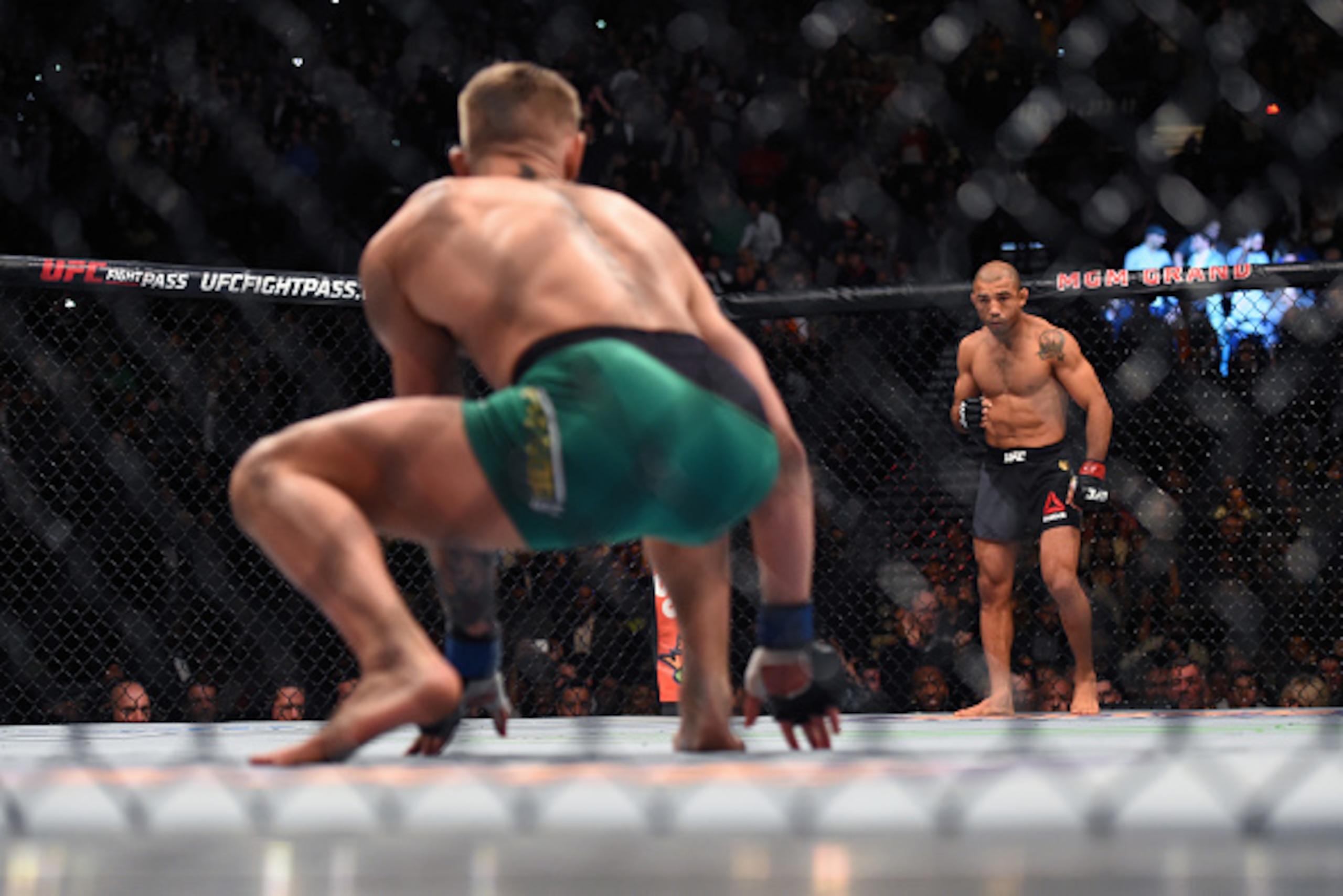 LAS VEGAS, NEVADA - DECEMBER 12: (L-R) Conor McGregor of Ireland crouches in his corner while staring down Jose Aldo of Brazil before their featherweight championship bout during the UFC 194 event inside MGM Grand Garden Arena on December 12, 2015 in Las LAS VEGAS, NEVADA - DECEMBER 12: (L-R) Conor McGregor of Ireland crouches in his corner while staring down Jose Aldo of Brazil before their featherweight championship bout during the UFC 194 event inside MGM Grand Garden Arena on December 12, 2015 in Las
