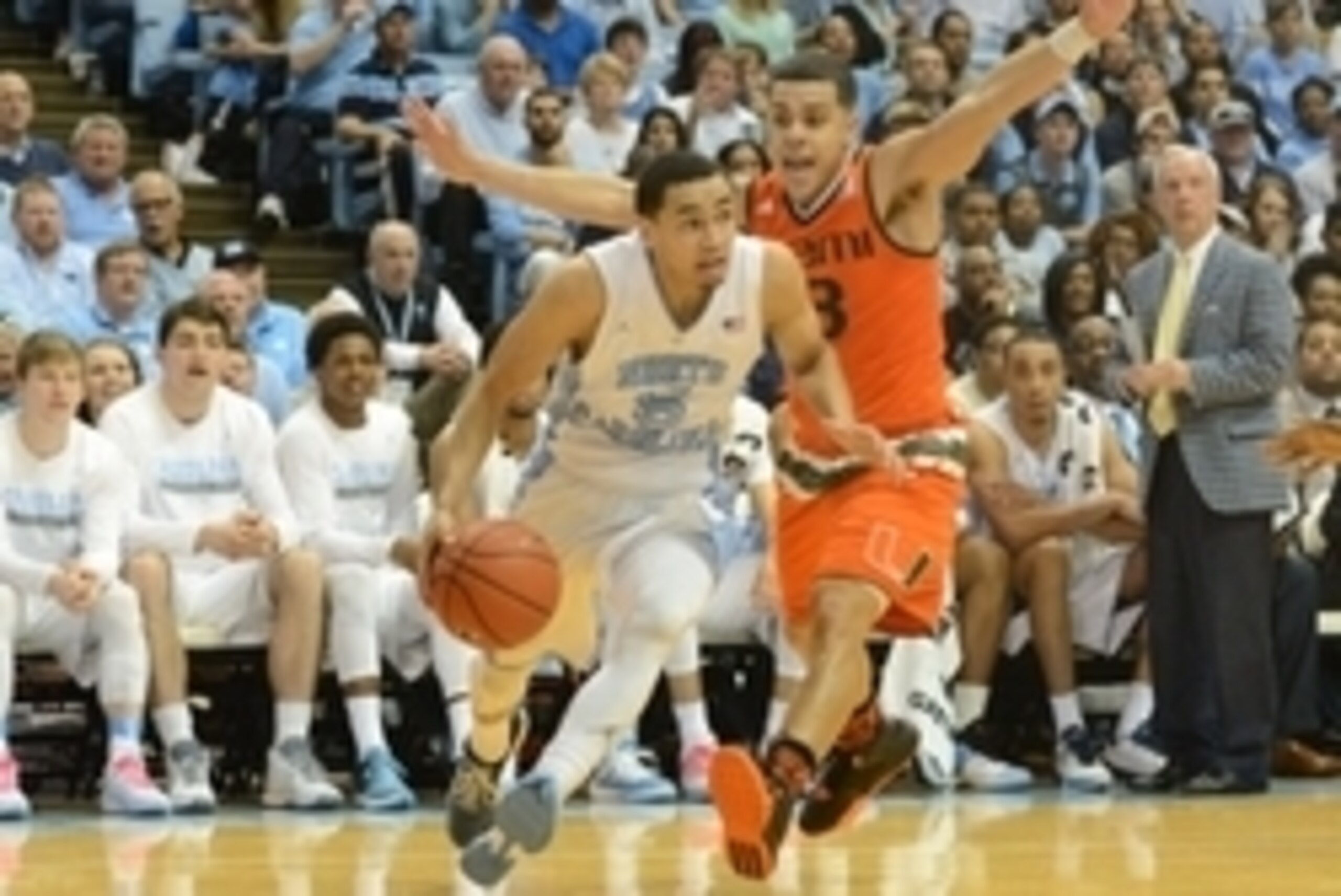Feb 20, 2016; Chapel Hill, NC, USA; North Carolina Tar Heels guard Marcus Paige (5) drives to the basket past Miami Hurricanes guard Angel Rodriguez (13) during the second half at Dean E. Smith Center. North Carolina won 96-71.  Mandatory Credit: Rob Kinn