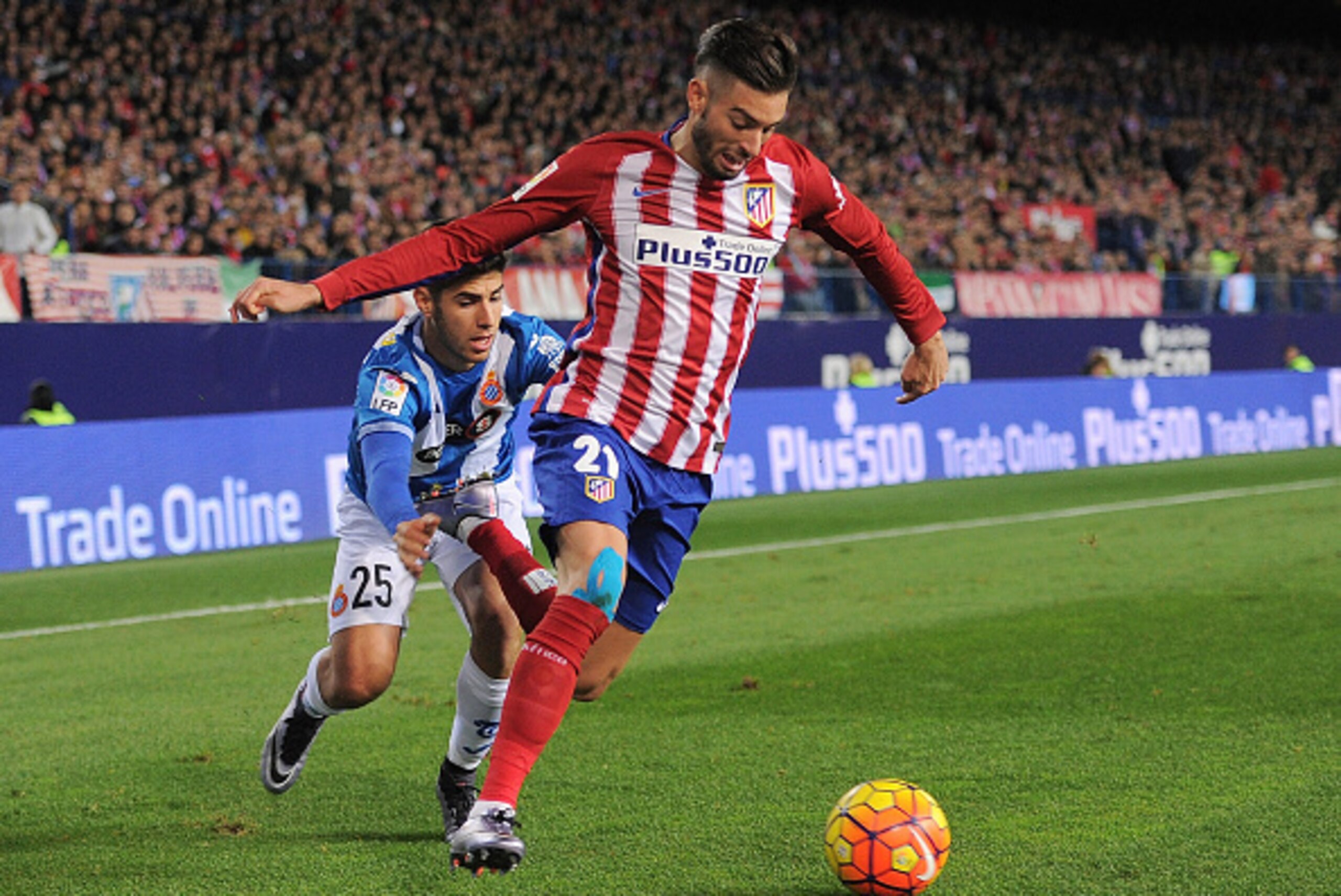 MADRID, SPAIN - NOVEMBER 28:  Yannick Carrasco of Club Atletico de Madrid gets past Marco Asensio of Real CD Espanyol during the La Liga match between Club Atletico de Madrid and Real CD Espanyol at Vicente Calderon Stadium on November 28, 2015 in Madrid,
