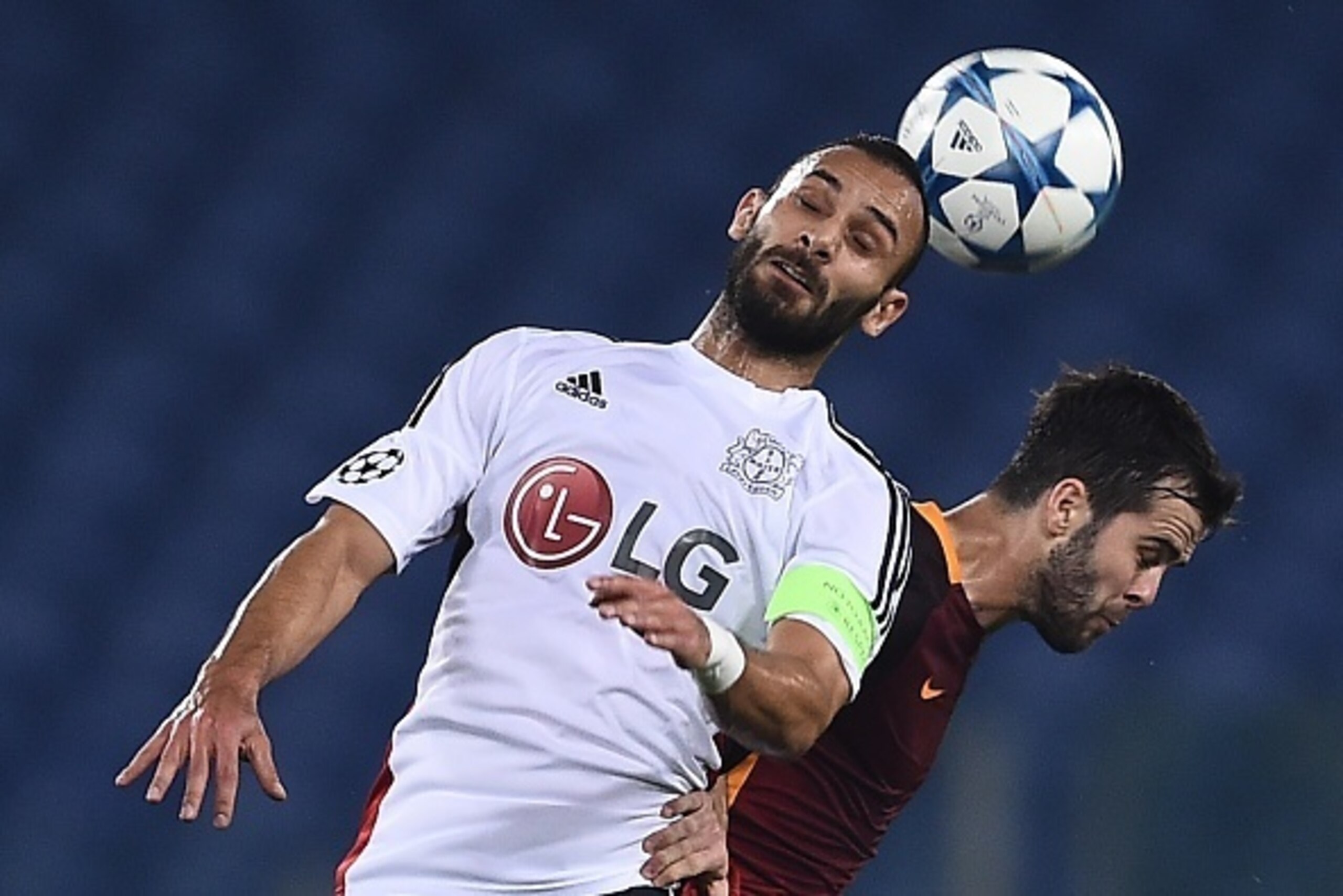 Roma's midfielder from Bosnia-Herzegovina Miralem Pjanic (R) fights for the ball with Leverkusen's Turkish defender Omer Toprak during the UEFA Champions League football match AS Roma vs Bayer Leverkusen on November 4, 2015 at the Olympic stadium in Rome.