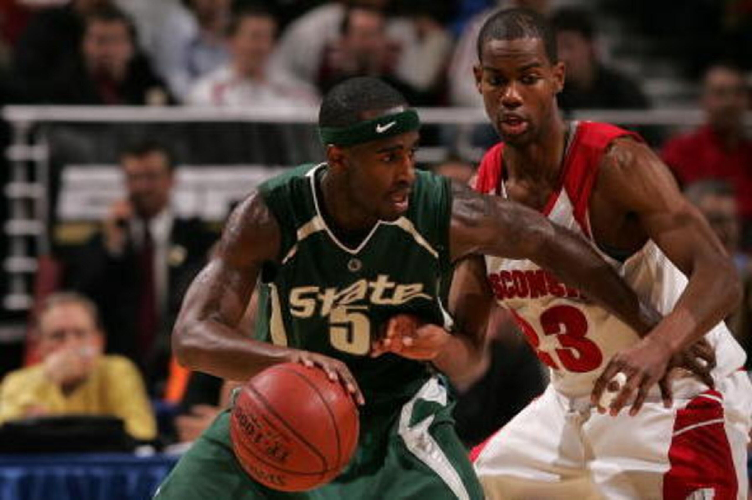 CHICAGO - MARCH 09:  Travis Walton #5 of the Michigan State Spartans moves the ball against Kammron Taylor #23 of the Wisconsin Badgers during the quarterfinals of the Big Ten Men's Basketball Conference Tournament March 9, 2007 at the United Center in Ch