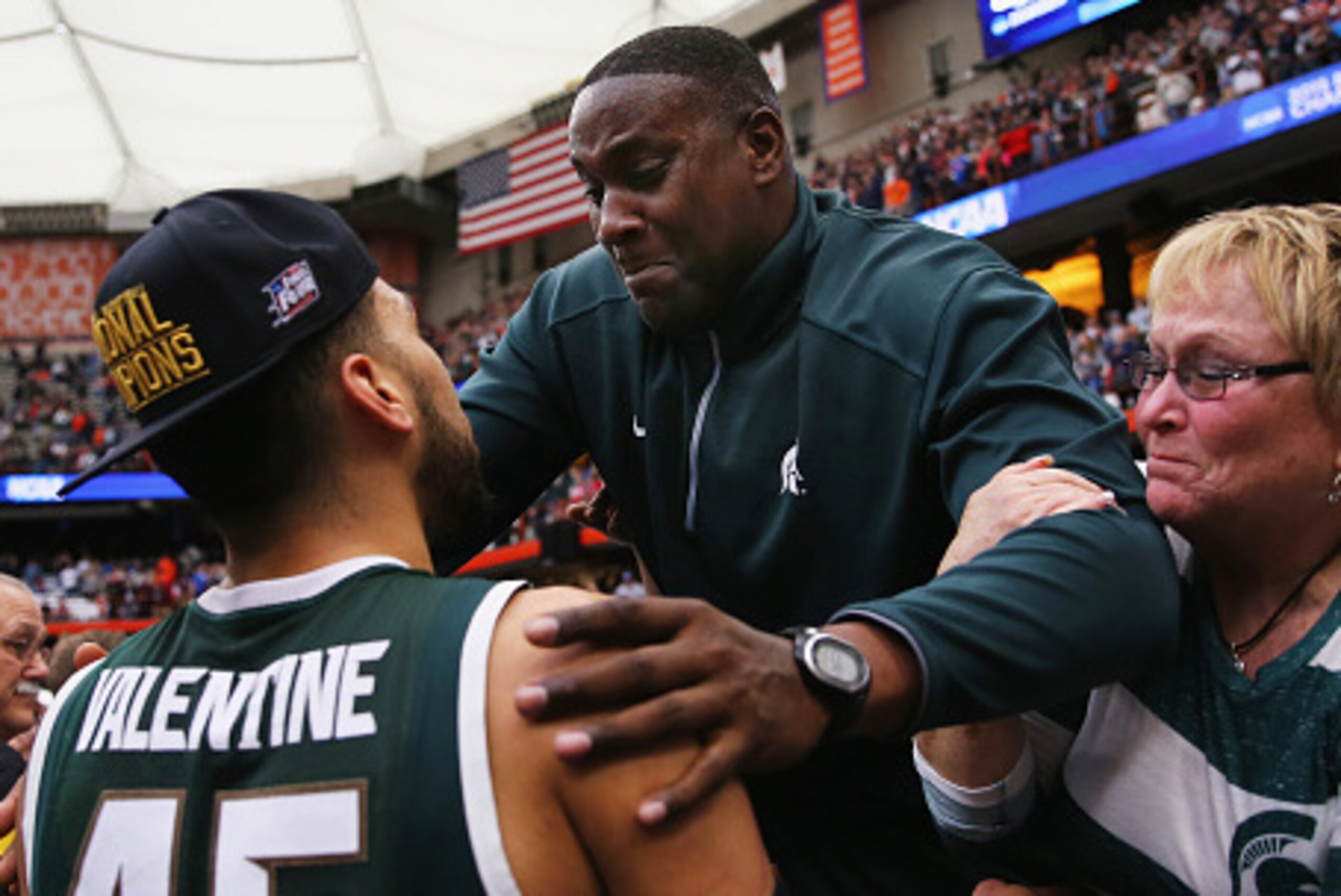 SYRACUSE, NY - MARCH 29:  Denzel Valentine #45 of the Michigan State Spartans celebrates with his parents Carlton and Kathy after defeating the Louisville Cardinals 76 to 70 in overtime of the East Regional Final of the 2015 NCAA Men's Basketball Tourname