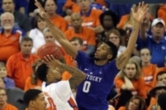Mar 1, 2016; Gainesville, FL, USA; Kentucky Wildcats forward Marcus Lee (00) defends Florida Gators guard Kasey Hill (0) shot during the second half at Stephen C. O'Connell Center. Kentucky Wildcats defeated the Florida Gators 88-79. Mandatory Credit: Kim