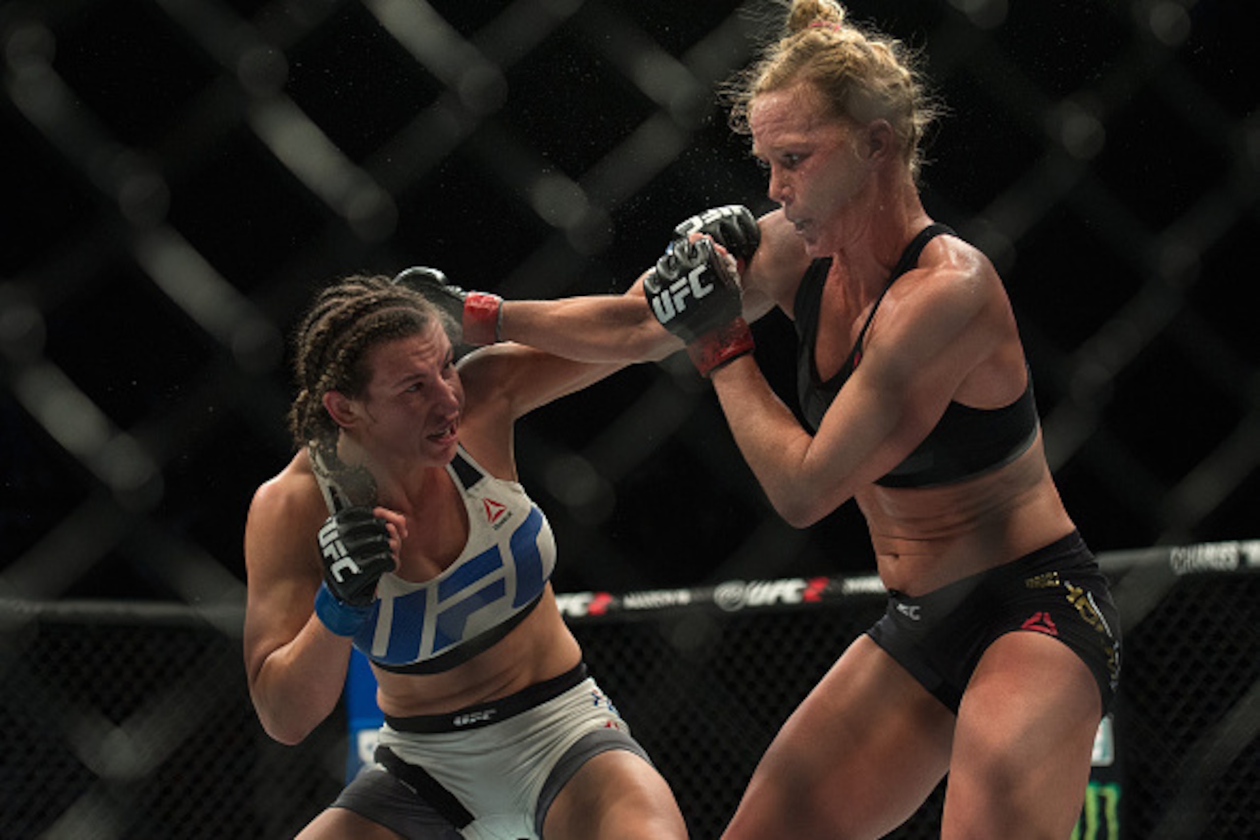 LAS VEGAS, NV - MARCH 5:   (R-L) Holly Holm exchanges punches with Miesha Tate during their women's bantamweight championship  bout during the UFC 196 in the MGM Grand Garden Arena on March 5, 2016 in Las Vegas, Nevada. (Photo by Brandon Magnus/Zuffa LLC/