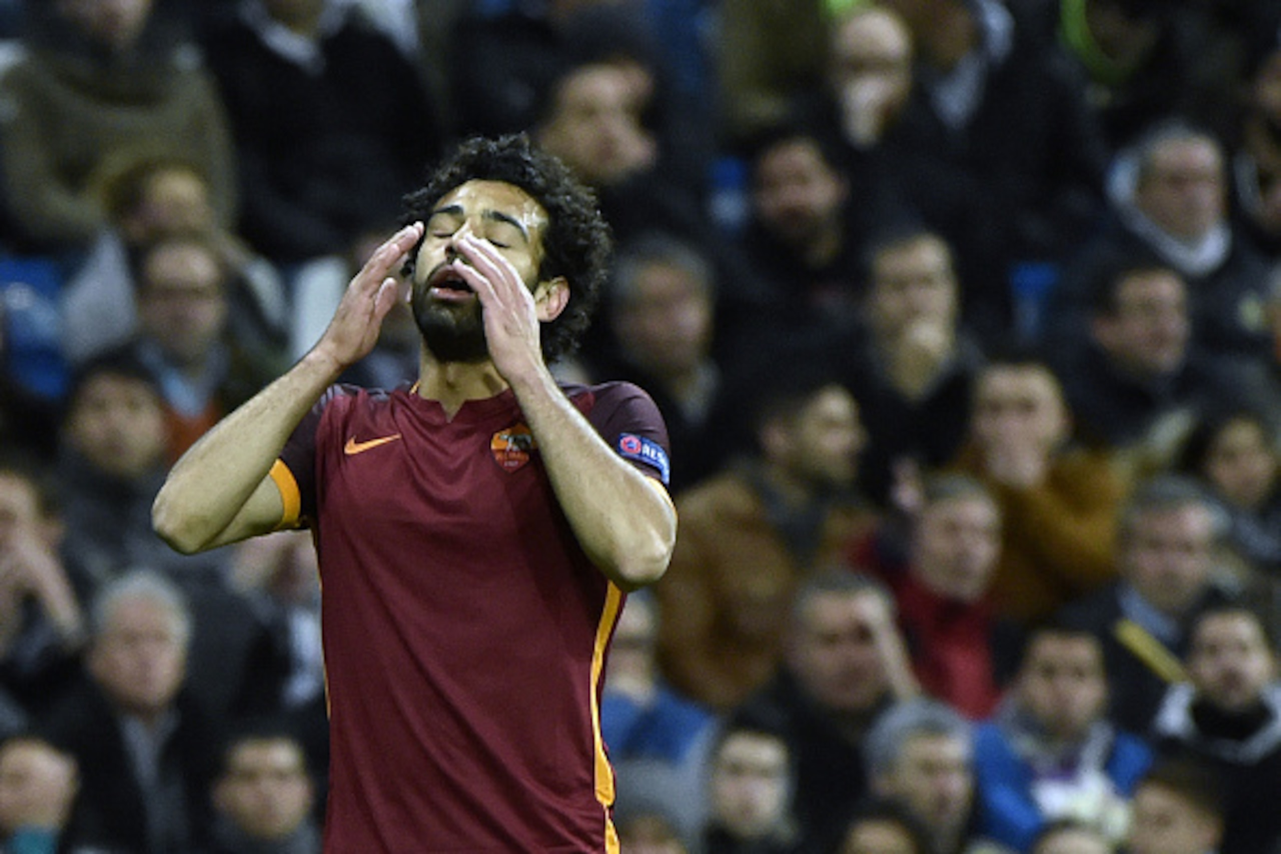 Roma's midfielder from Egypt Mohamed Salah reacts to missing a goal opportunity  during the UEFA Champions League round of 16, second leg football match Real Madrid FC vs AS Roma at the Santiago Bernabeu stadium in Madrid on March 8, 2016. / AFP / GERARD 