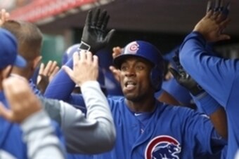 Oct 1, 2015; Cincinnati, OH, USA; Chicago Cubs right fielder Austin Jackson (left) is congratulated by teammates after hitting a hit a three-run home run against the Cincinnati Reds in the third inning at Great American Ball Park. Mandatory Credit: David