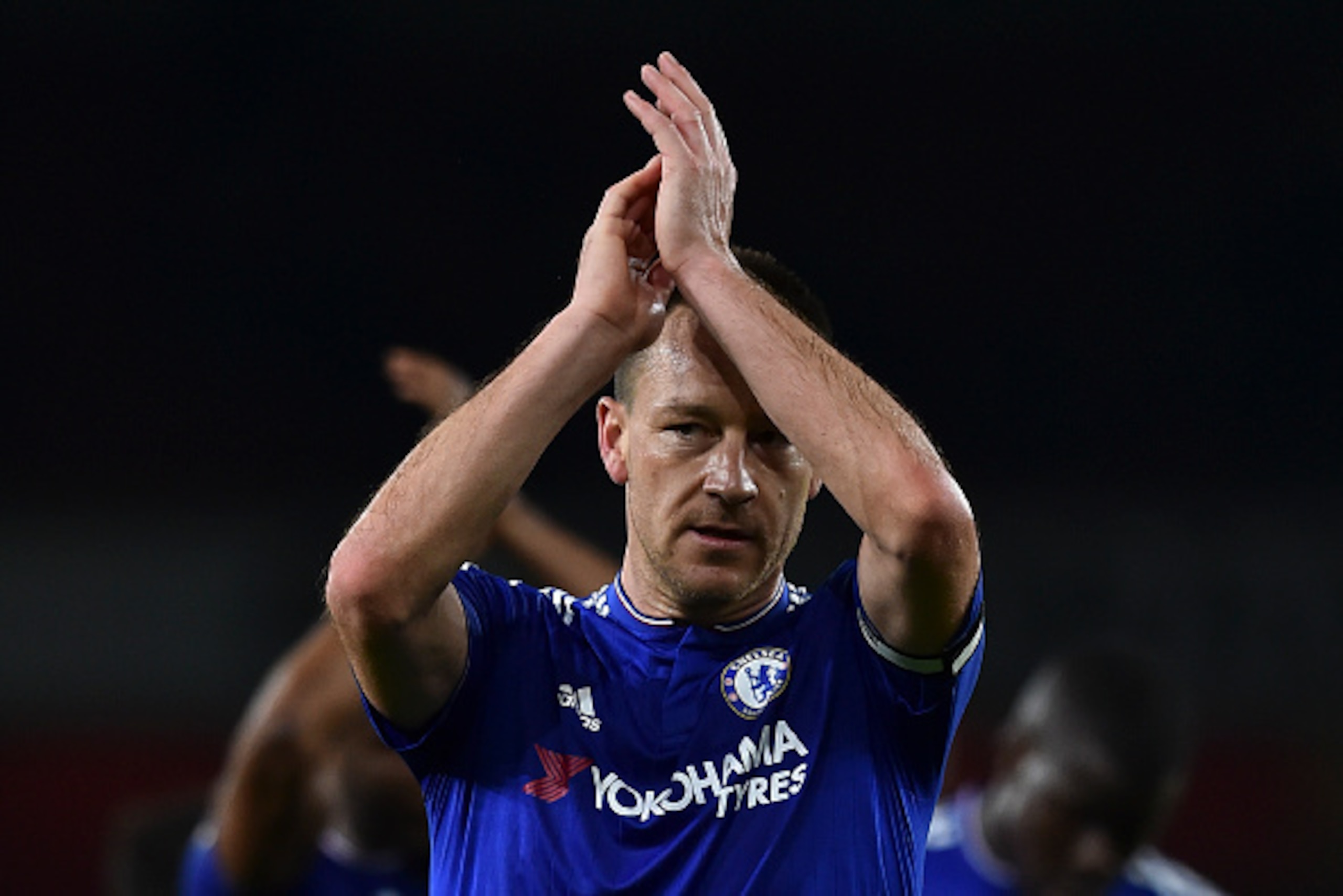 Chelsea's English defender John Terry applauds supporters after the English Premier League football match between Arsenal and Chelsea at the Emirates Stadium in London on January 24, 2016. Chelsea won the game 1-0. AFP PHOTO / BEN STANSALL

RESTRICTED TO 