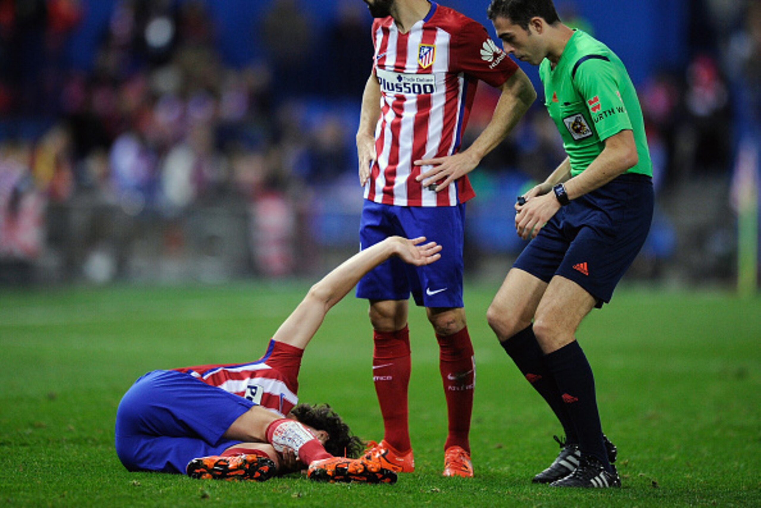 MADRID, SPAIN - NOVEMBER 28:  Tiago Mendes of Club Atletico de Madrid lies injured beside Juanfran during the La Liga match between Club Atletico de Madrid and Real CD Espanyol at Vicente Calderon Stadium on November 28, 2015 in Madrid, Spain.  (Photo by 