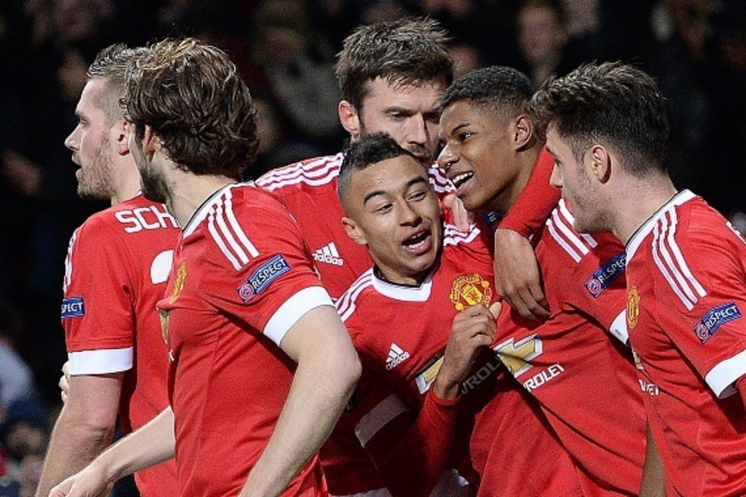 Manchester United's English striker Marcus Rashford (2R) celebrates scoring his team's third goal during the UEFA Europa League round of 32, second leg football match between Manchester United and and FC Midtjylland at Old Trafford in Manchester, north we