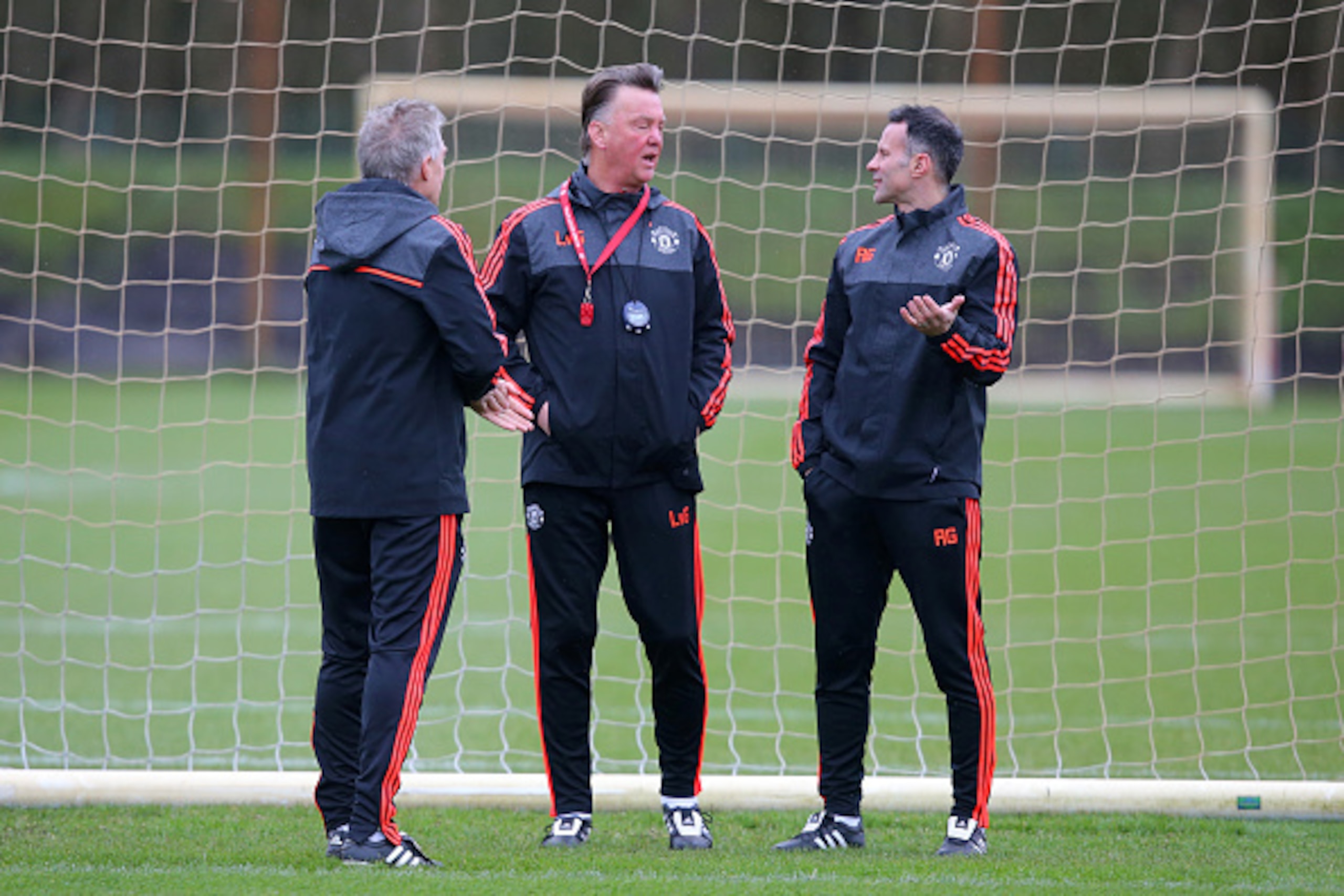 MANCHESTER, ENGLAND - MARCH 09:  Louis van Gaal, manager of Manchester Uniited speaks with his assistant Ryan Giggs during a training session ahead of the UEFA Europa League round of 16 first leg match between Liverpool and Manchester United at Aon Traini