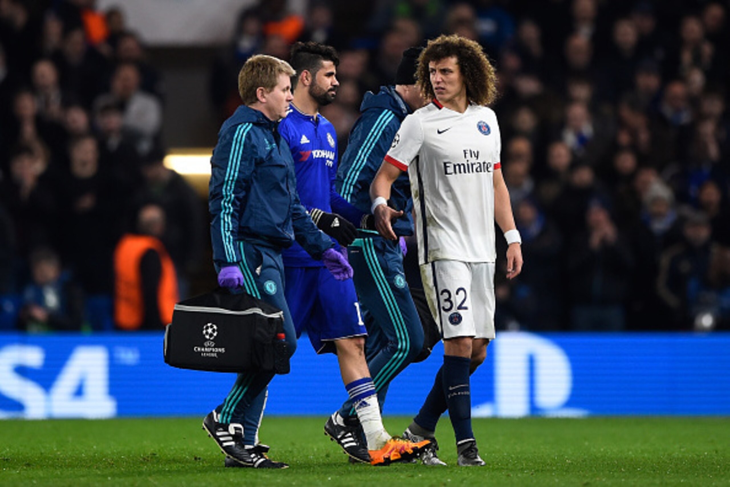LONDON, ENGLAND - MARCH 09:  The injured Diego Costa of Chelsea is consoled by David Luiz of PSG  as he leaves the pitch during the UEFA Champions League round of 16, second leg match between Chelsea and Paris Saint Germain at Stamford Bridge on March 9, 
