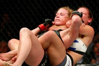 Tate sinks in the fight-ending choke against Holm.