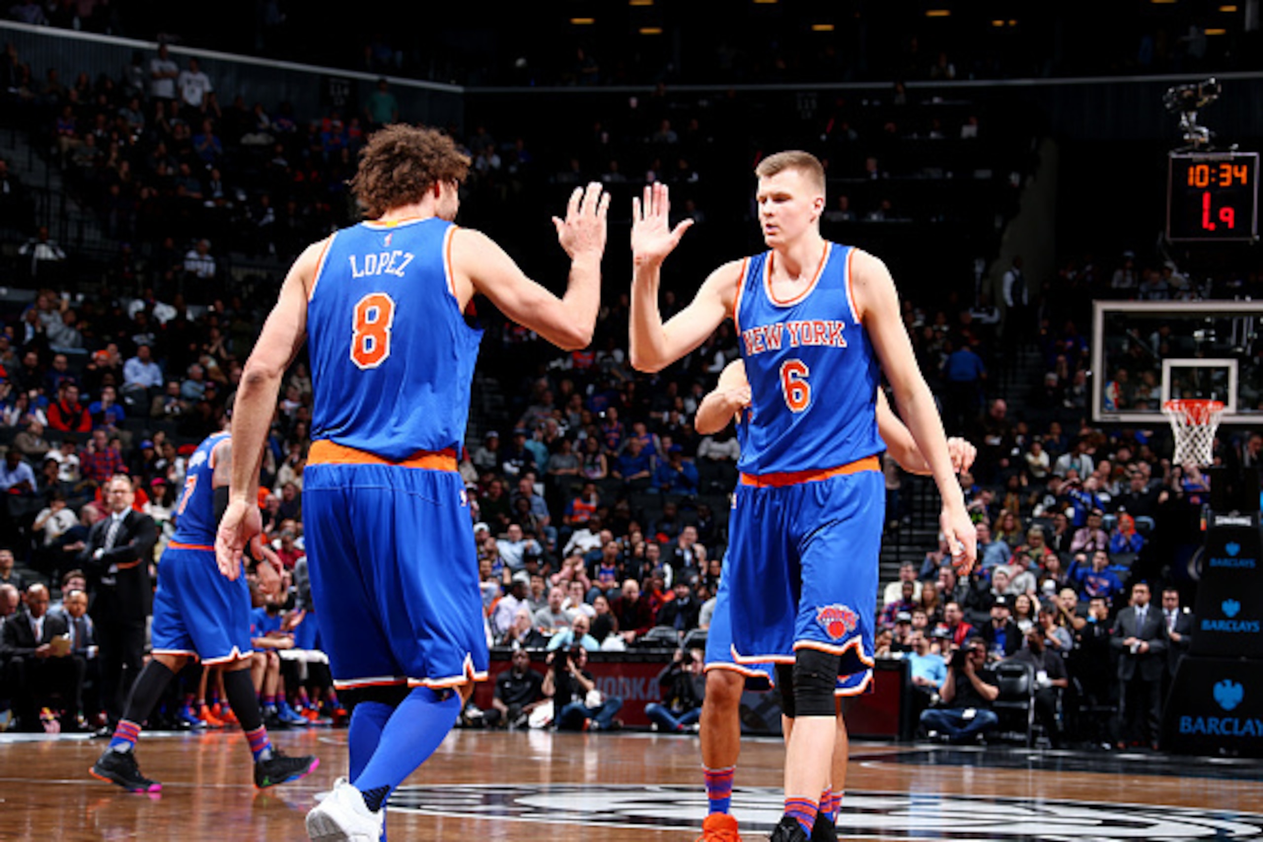 BROOKLYN, NY - FEBRUARY 19: Kristaps Porzingis #6 celebrates with Robin Lopez #8 of the New York Knicks against the Brooklyn Nets on February 19, 2016 at Barclays Center in Brooklyn, New York. NOTE TO USER: User expressly acknowledges and agrees that, by 