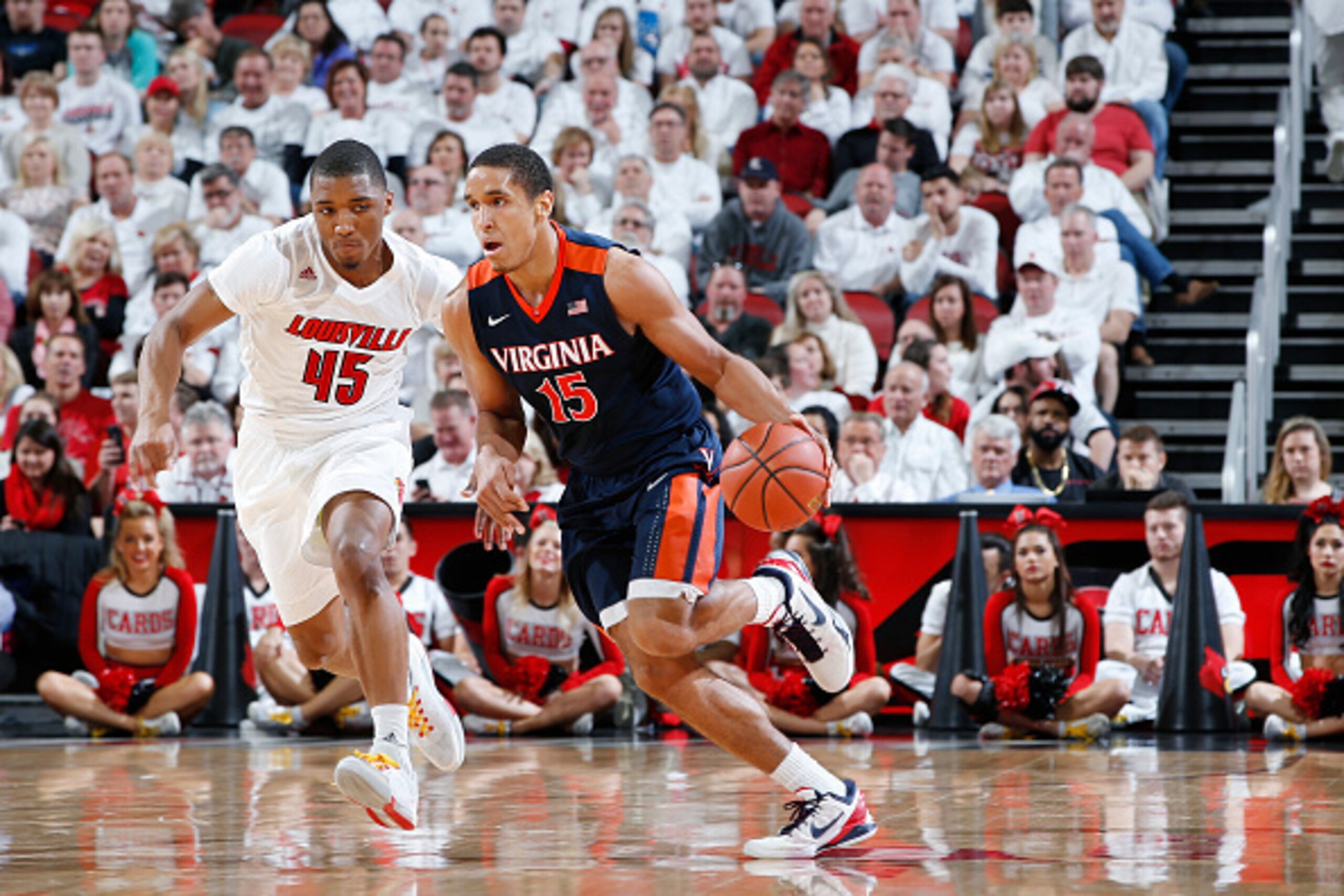 LOUISVILLE, KY - JANUARY 30: Malcolm Brogdon #15 of the Virginia Cavaliers brings the ball up court against Donovan Mitchell #45 of the Louisville Cardinals during the game at KFC Yum! Center on January 30, 2016 in Louisville, Kentucky. Virginia defeated 